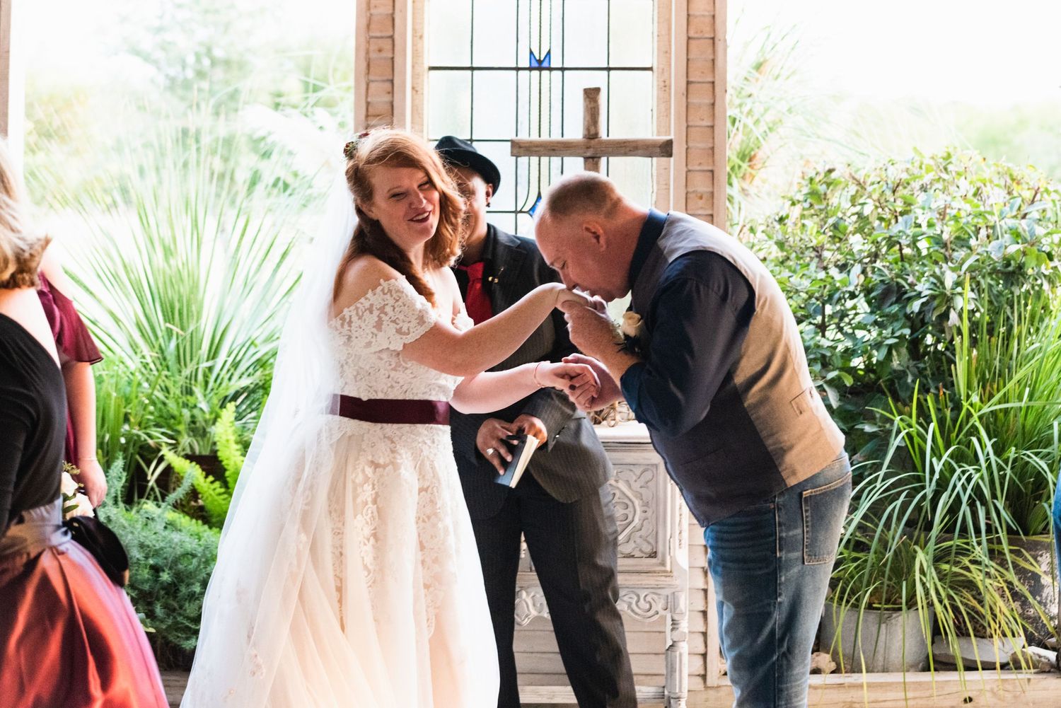 A touching moment during wedding vows as the couple shares emotional laughter.