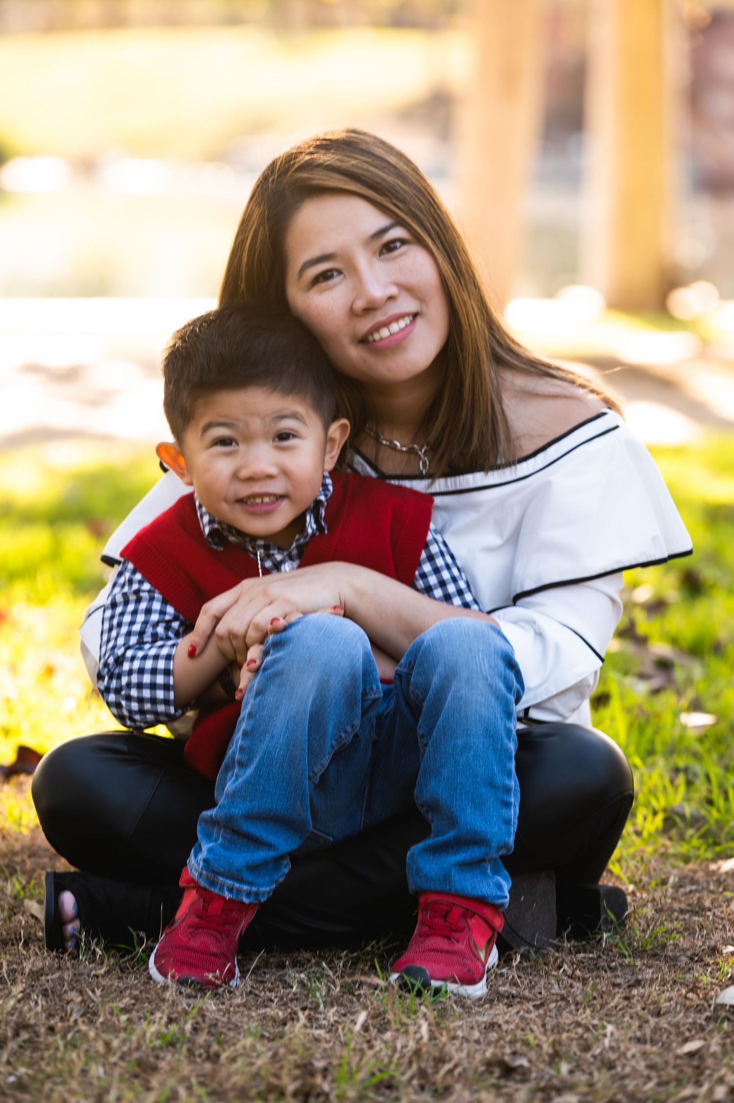 A candid moment of parent and child sitting together outdoors wearing coordinated outfits.