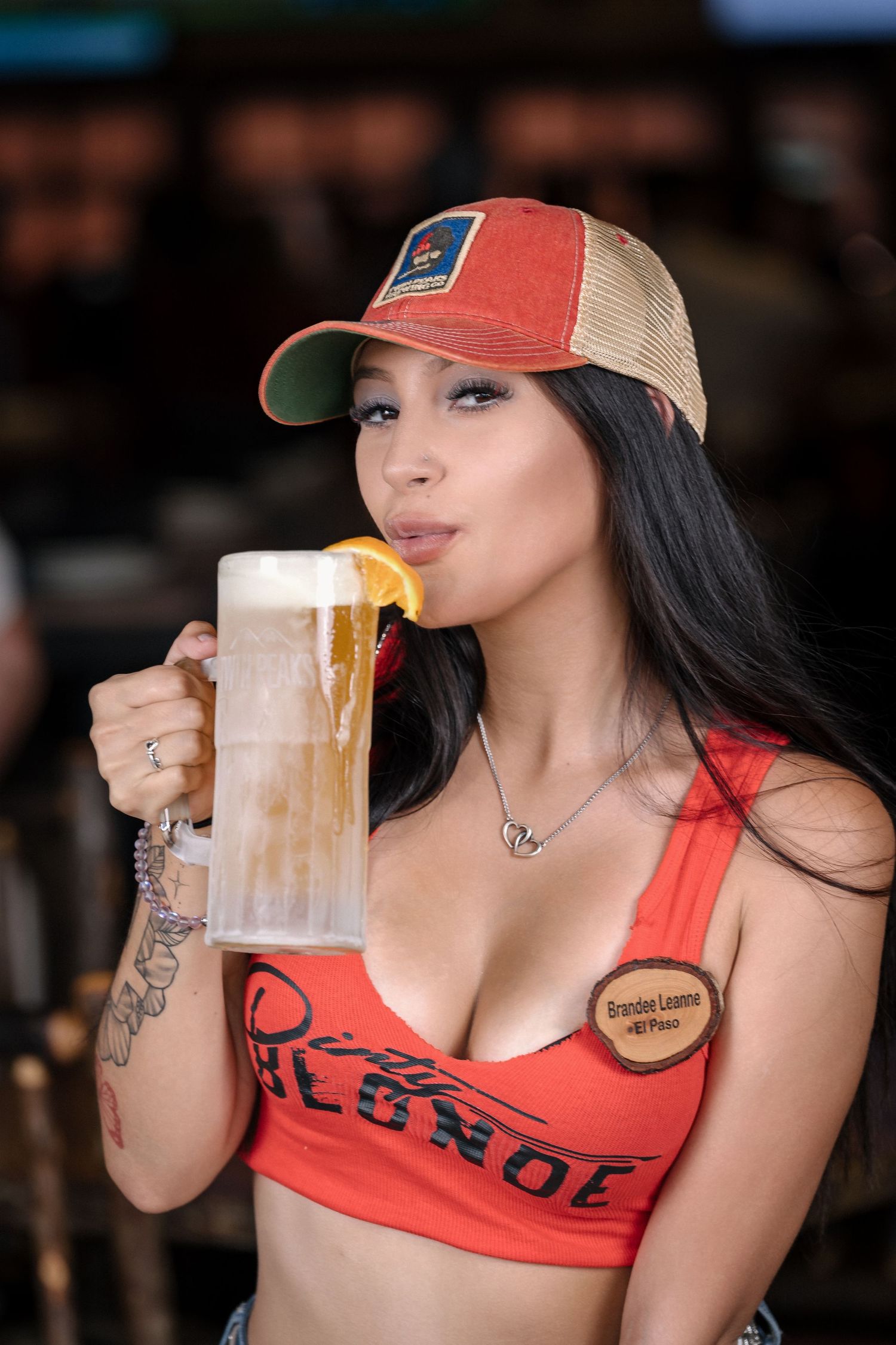 Bar promotional image with beer and branded casual attire.