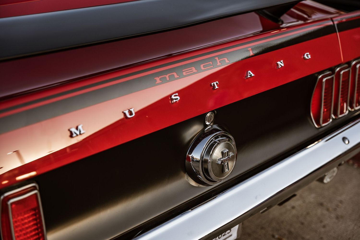 Close up detail shot of red vintage Mustang lettering and trim.