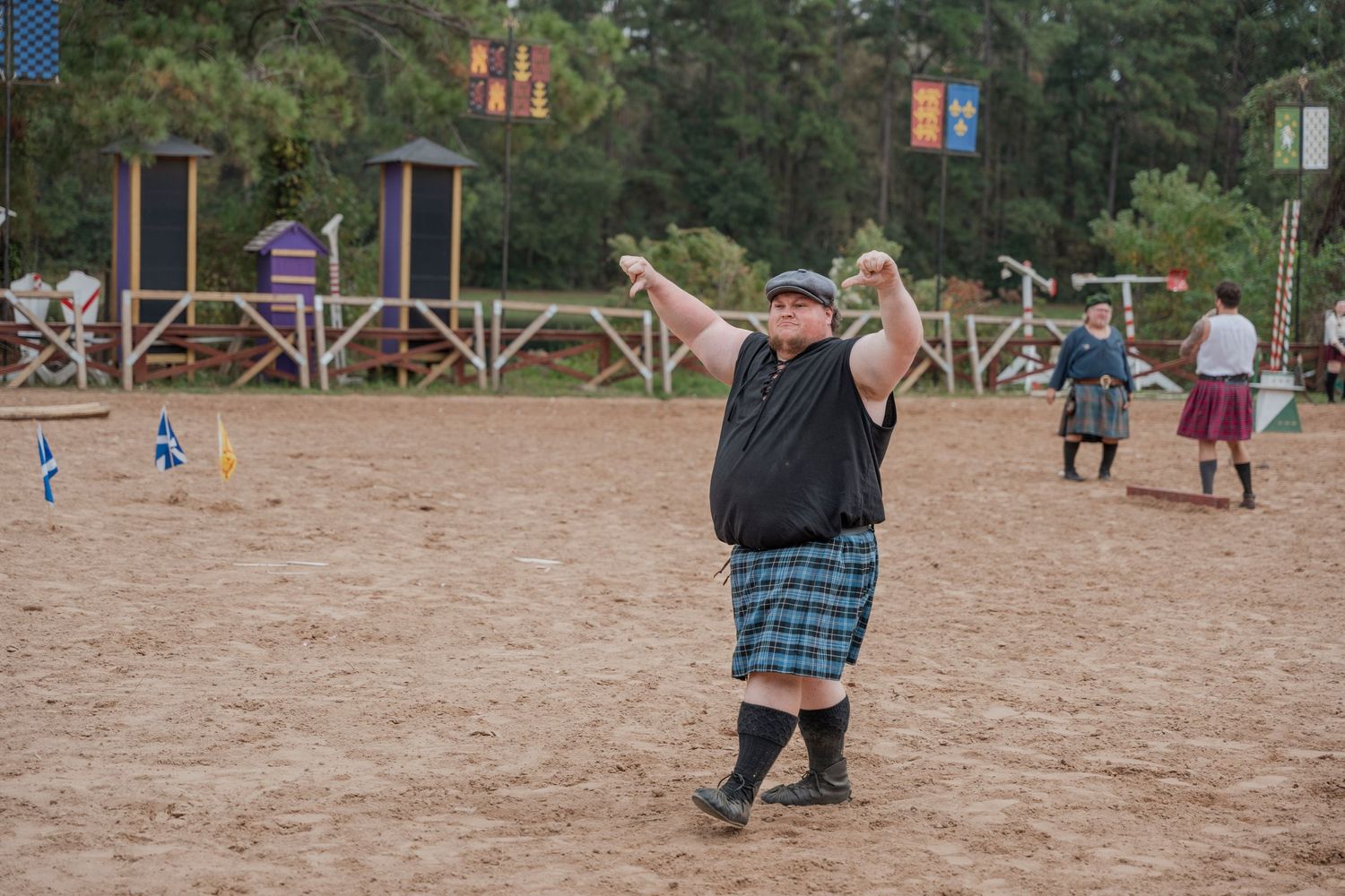 Person in kilt demonstrating traditional Scottish highland games throw at renaissance faire.