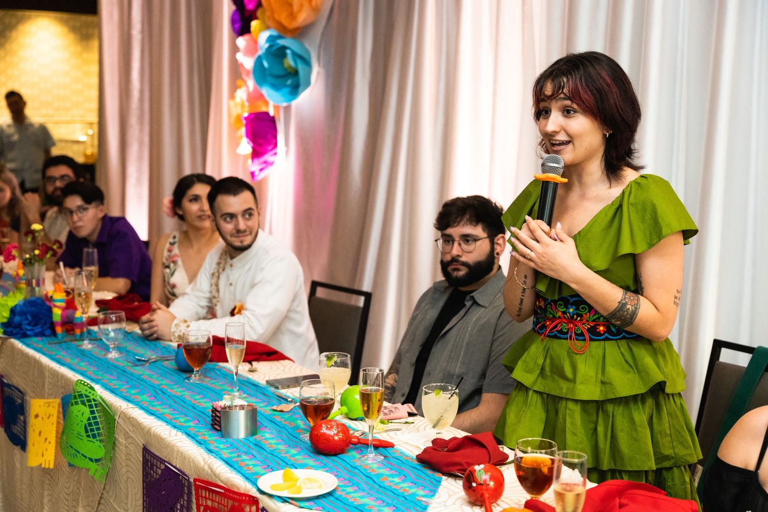 A celebration event with colorful balloon decorations and a blue table setting.