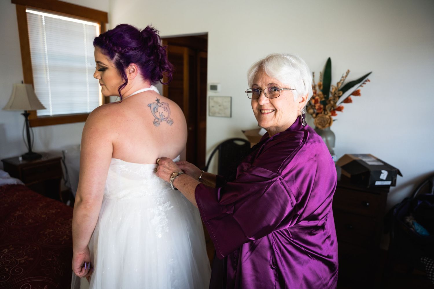 Final dress adjustments being made on a wedding day.