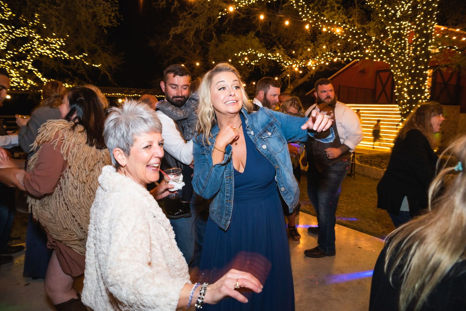 Guests enjoying themselves on the dance floor at an evening wedding reception.