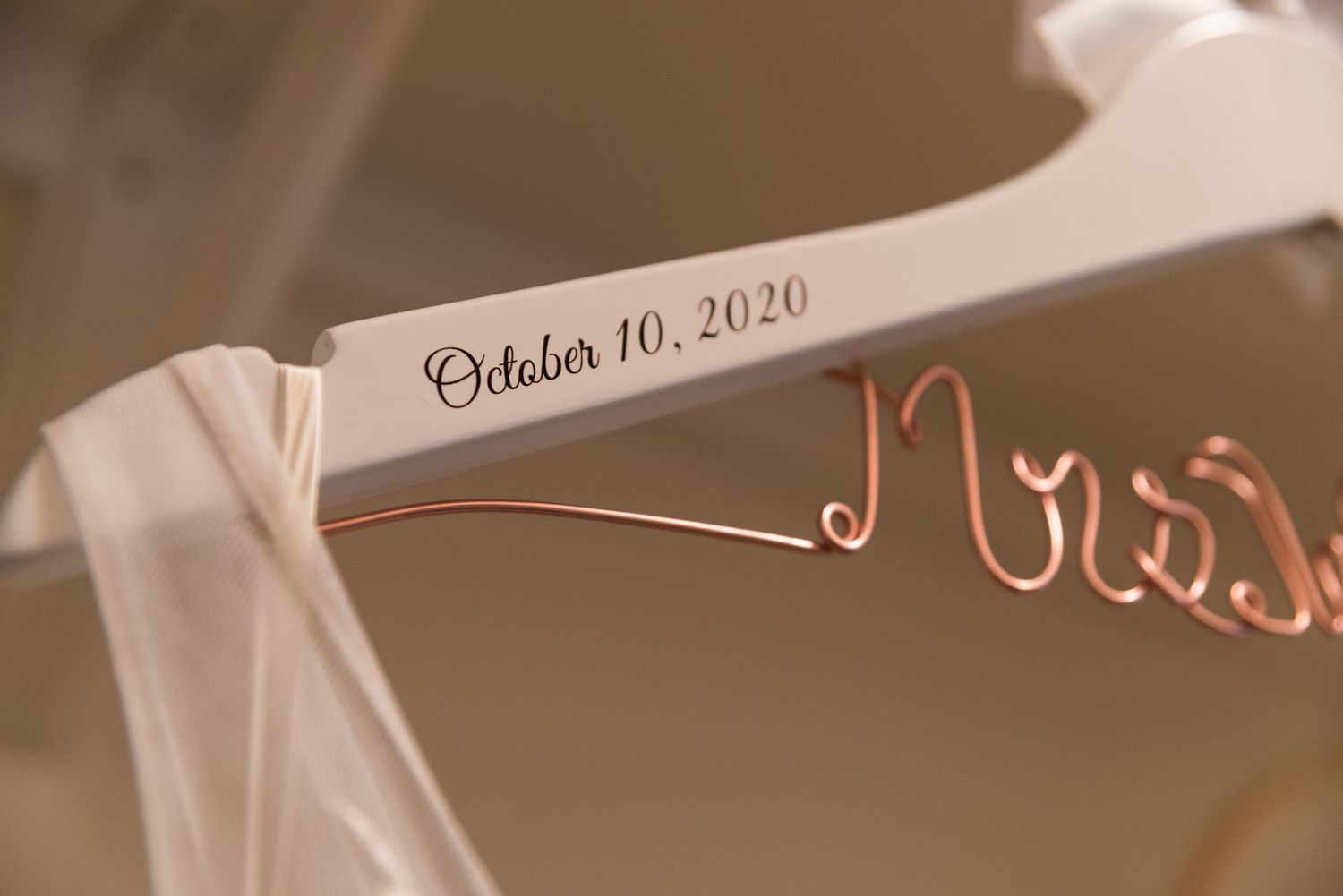 Custom wedding dress hanger showing October 10 2020 date in rose gold lettering.