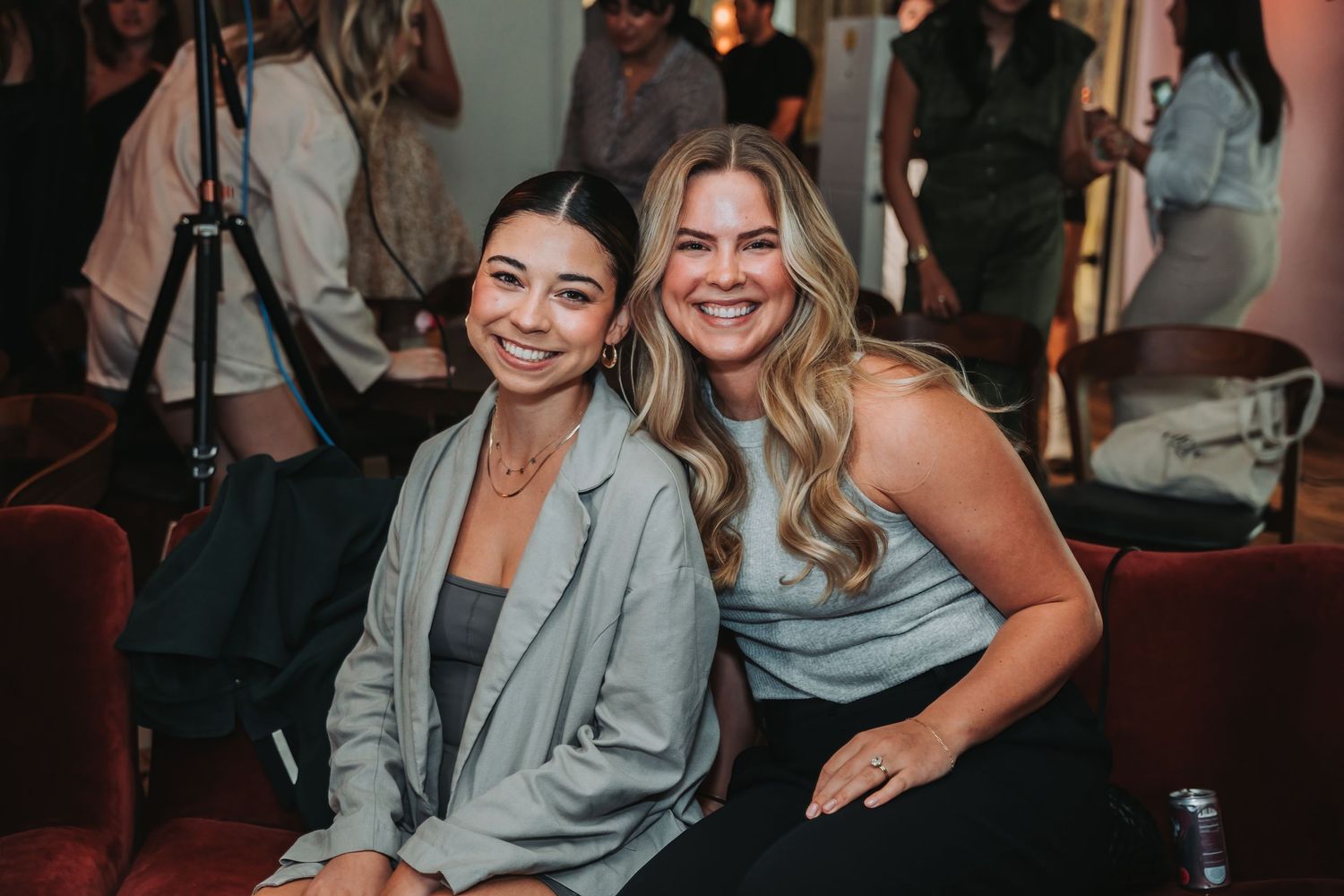 A group of people celebrating and socializing at an indoor event wearing business casual attire.
