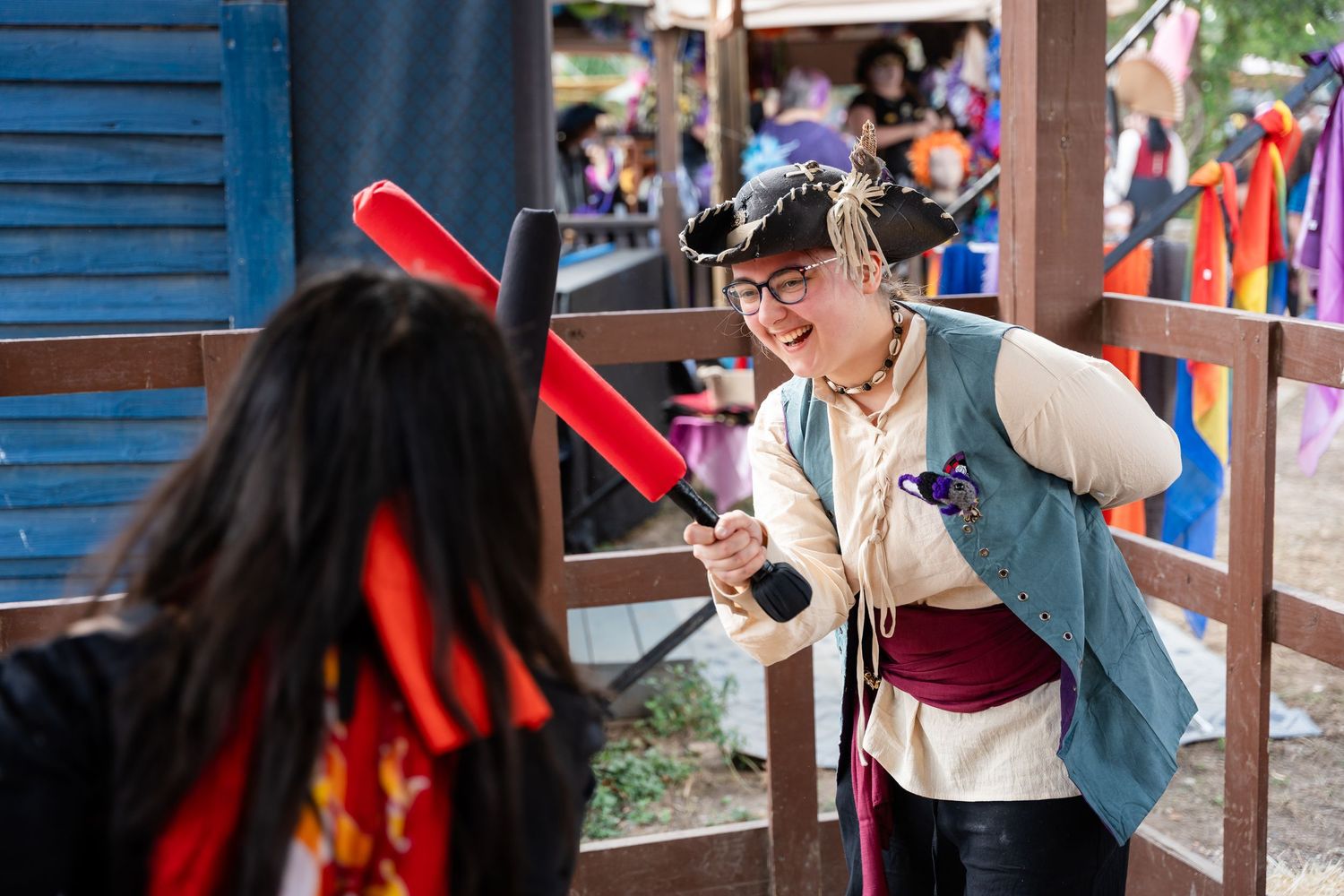 A person in traditional Korean hanbok dress participates in a cultural ceremony at an outdoor venue.