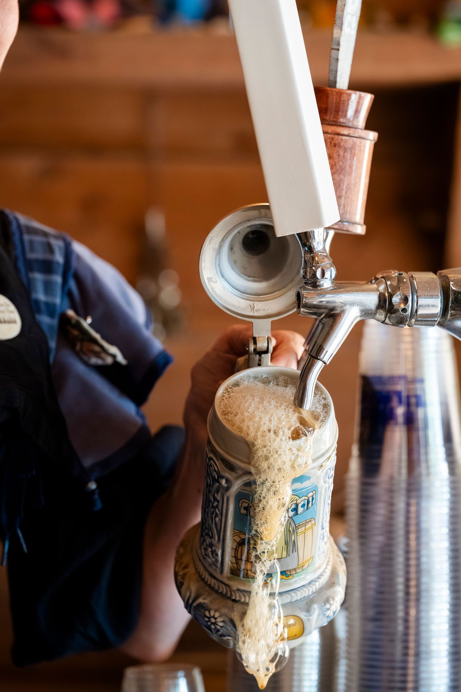 Sequence showing a beer can being opened with a wall-mounted bottle opener in a rustic setting.