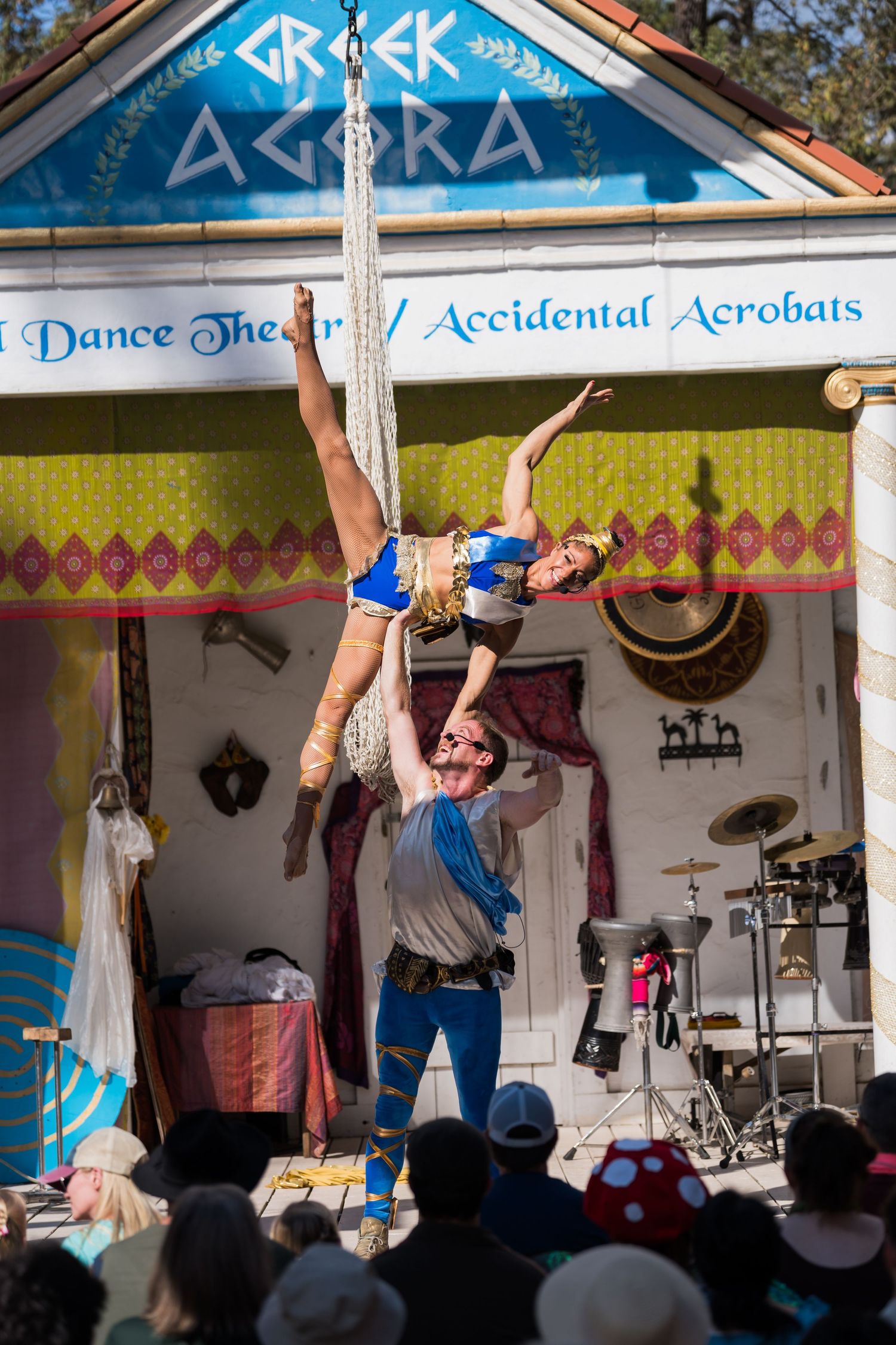 Acrobatic performers execute an aerial stunt at outdoor festival show.