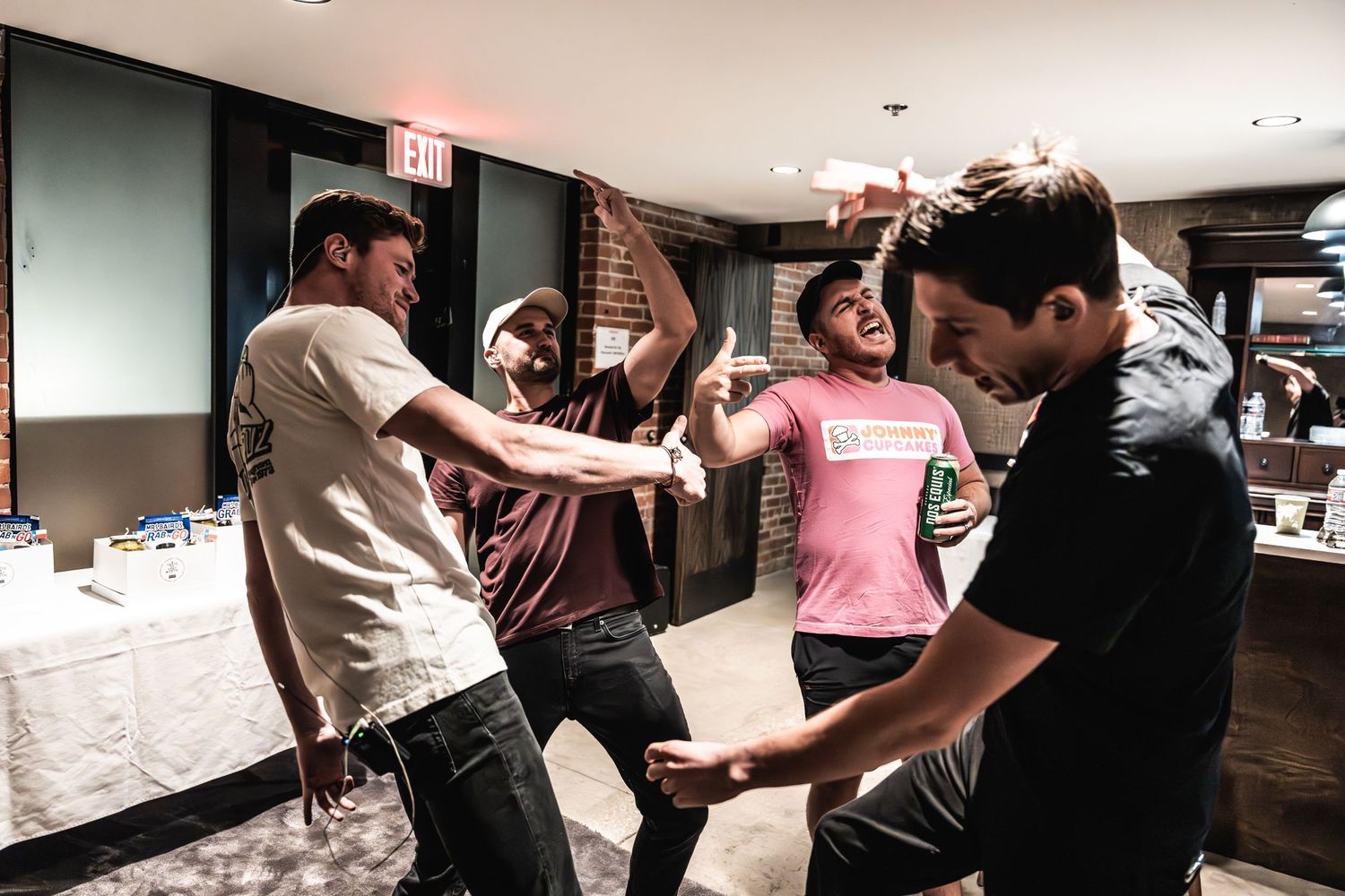 Group of people dancing and having fun in a casual indoor setting.
