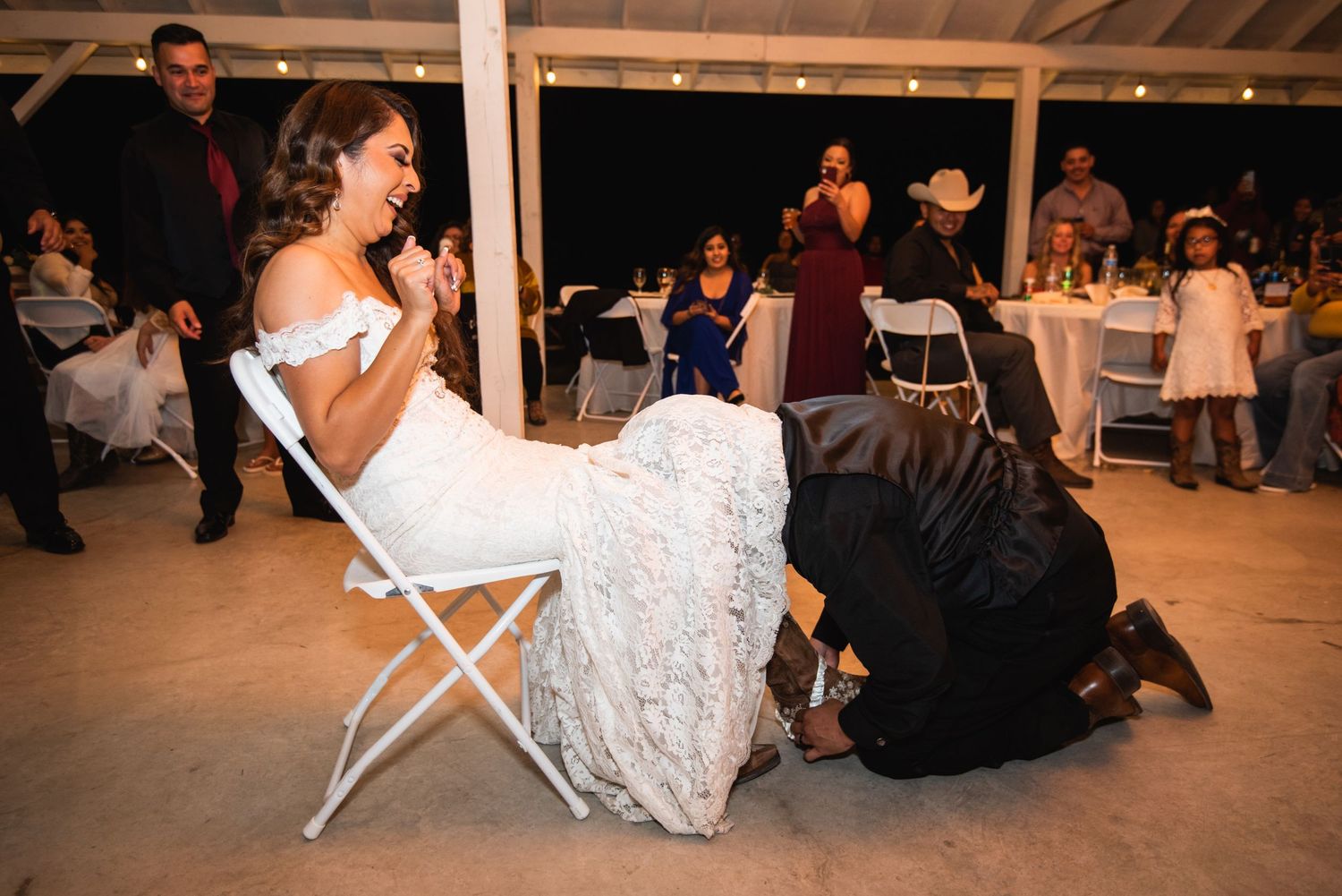 Wedding reception activity with guests participating in a traditional game or ritual.