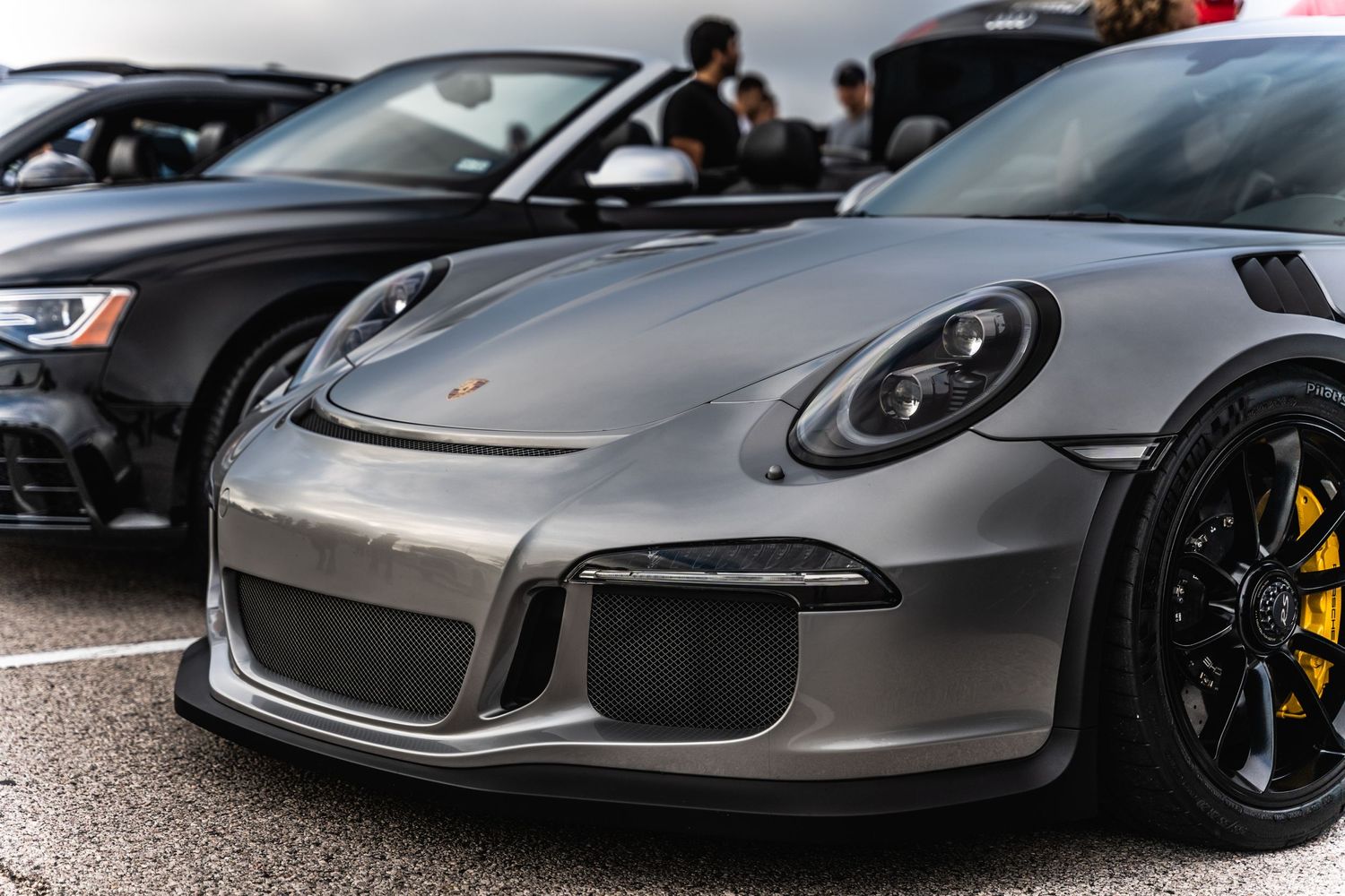 Side profile of silver Porsche 911 GT3 showcasing aggressive aerodynamic design.