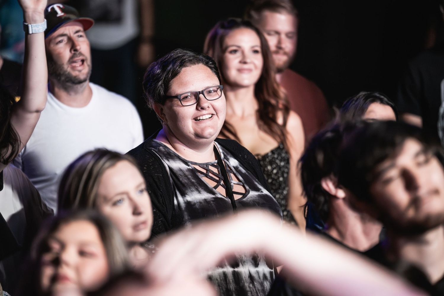 Concert crowd watches intently during live music performance.