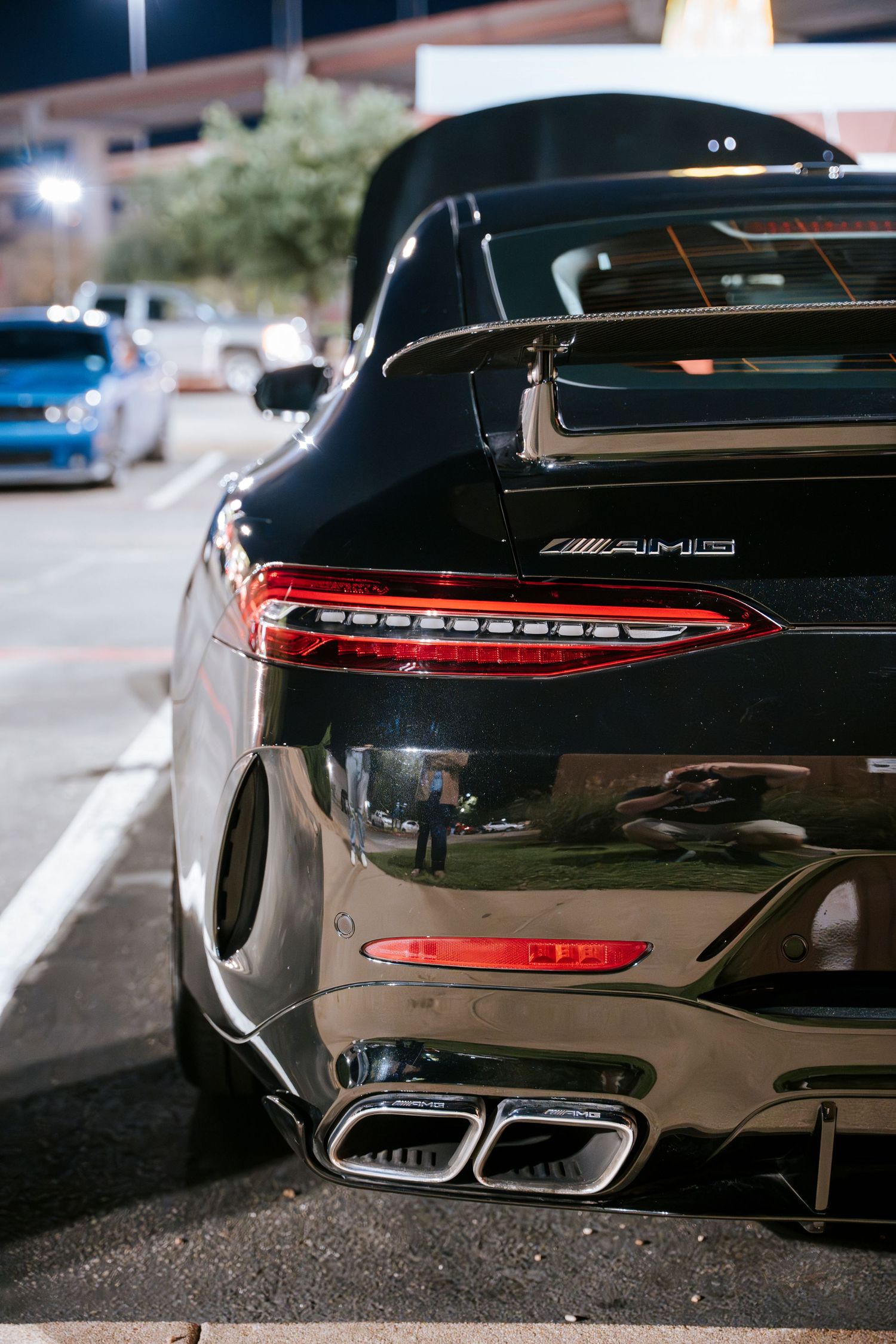 Close-up detail of Mercedes performance vehicle taillights and exhaust system.