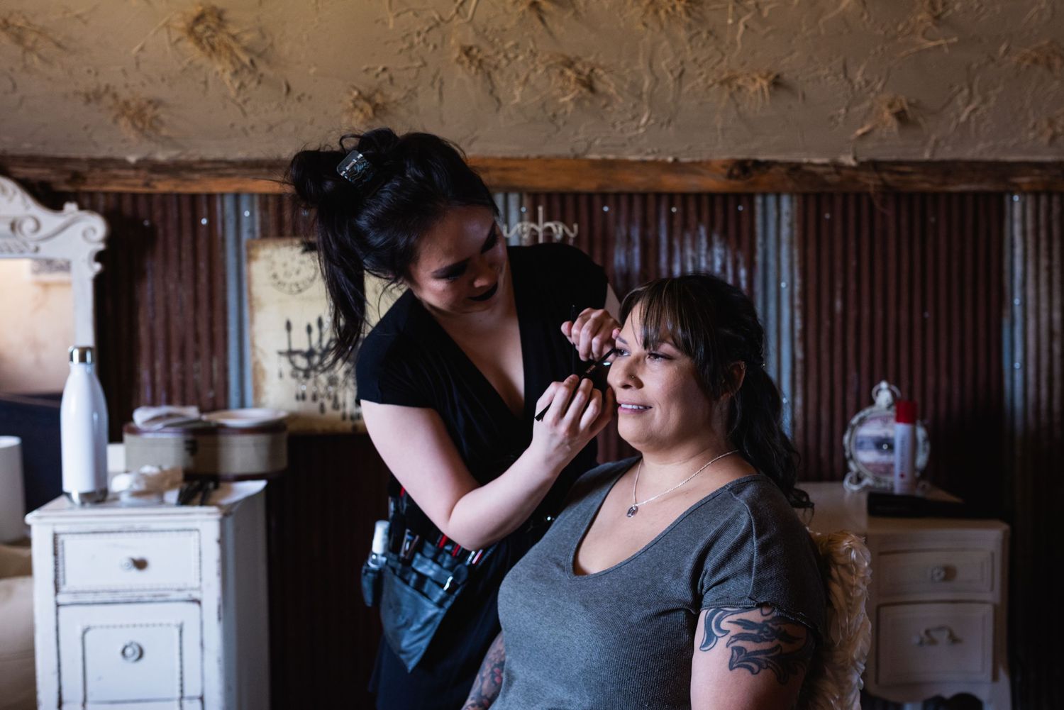 Candid moment of hair styling preparation indoors.