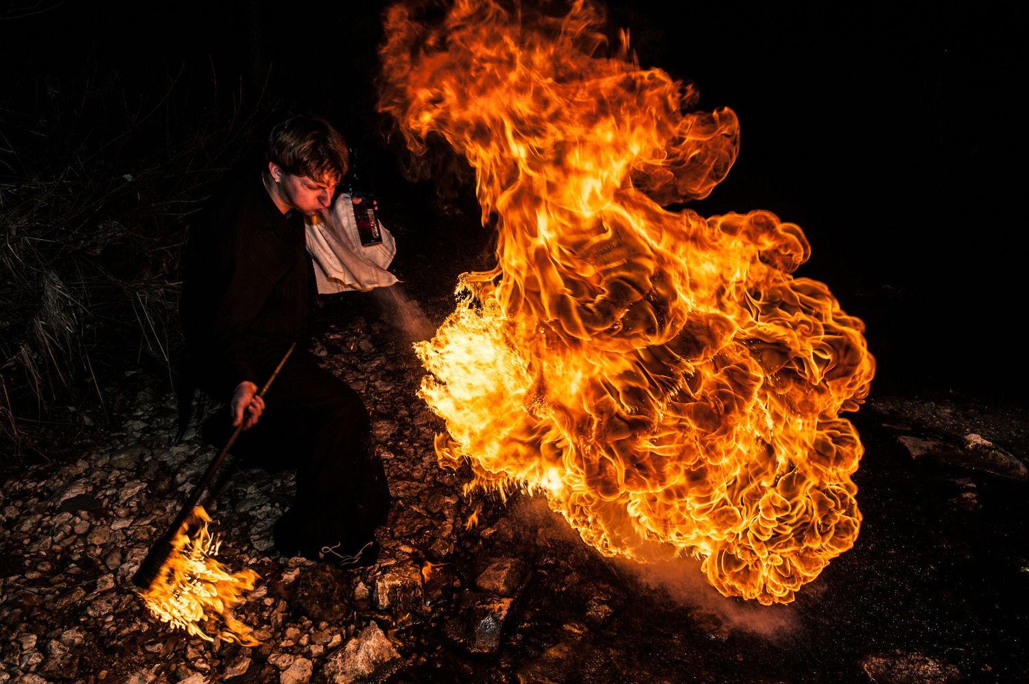 Bright orange flames dance against a dark background in a dramatic fire photography sequence.