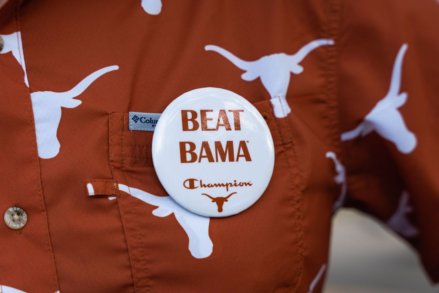 A burnt orange shirt with Texas Longhorns logos and a 'Beat Bama' button pin.