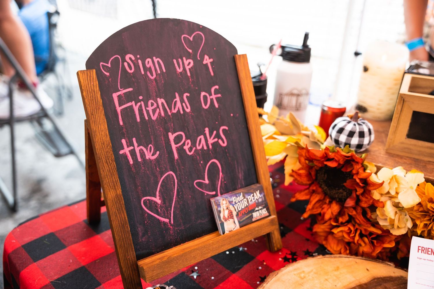 Chalkboard sign reading 'Sign up 4 Friends of the Peaks' with hearts and fall decorations.