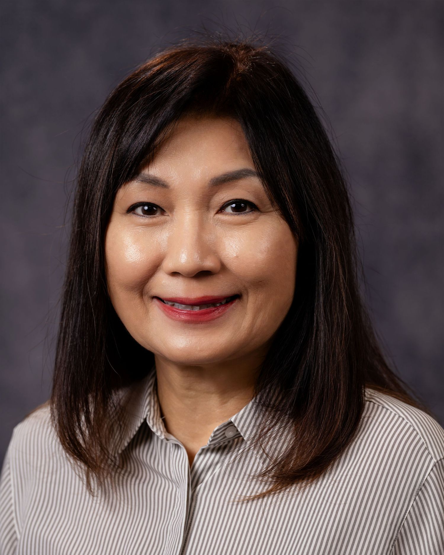 Professional headshot series showing same person in striped button-down shirt with different expressions and poses.