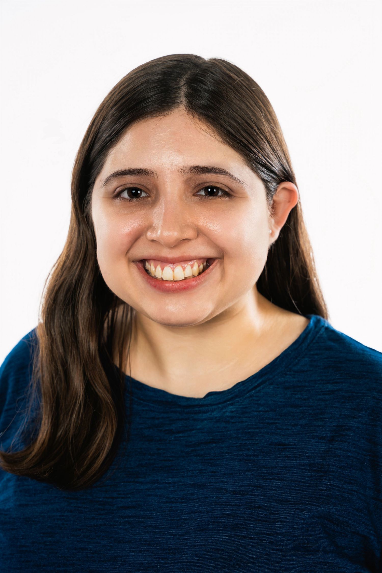 A portrait of a woman in a navy blue sweater against a white background.