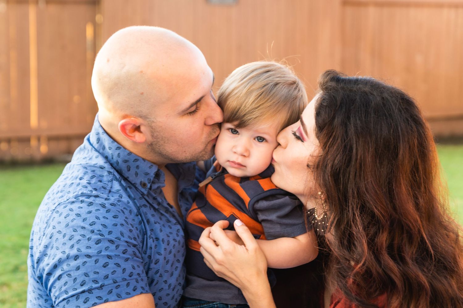 Intimate family moment captured outdoors with warm lighting and natural expressions.