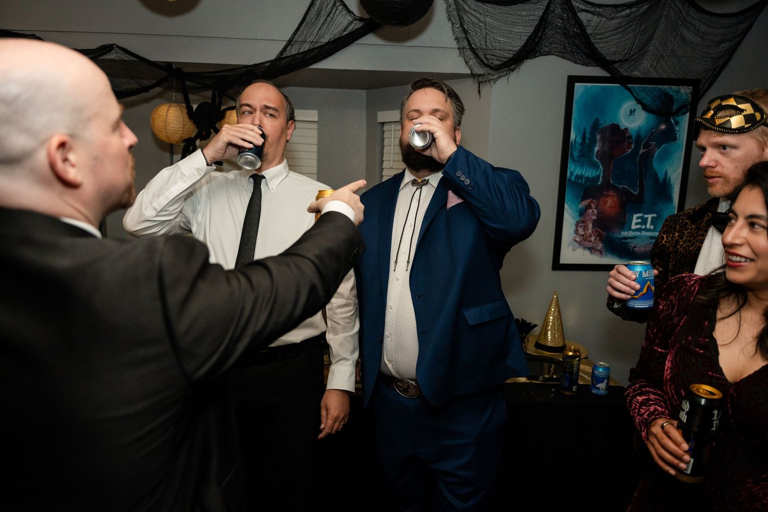 Wedding guests toast and celebrate during a lively reception party moment.