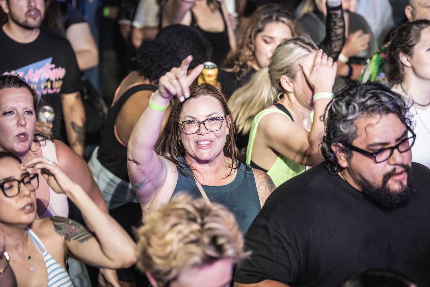 A crowded audience watches intently with focused expressions during a live performance event.