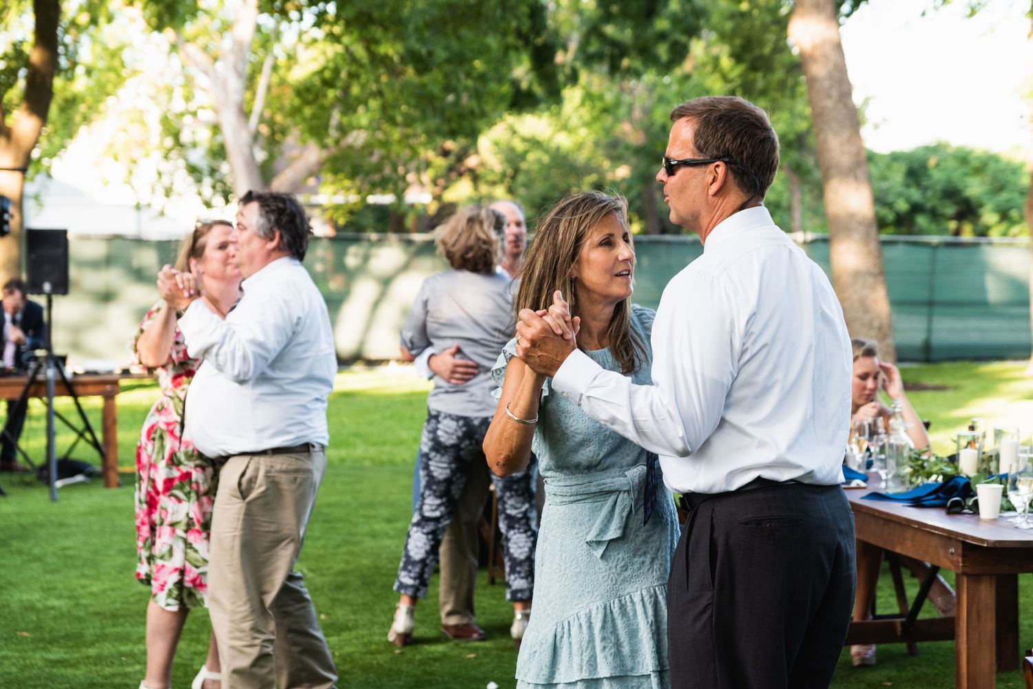 Guests dancing on the lawn during an elegant outdoor garden reception.