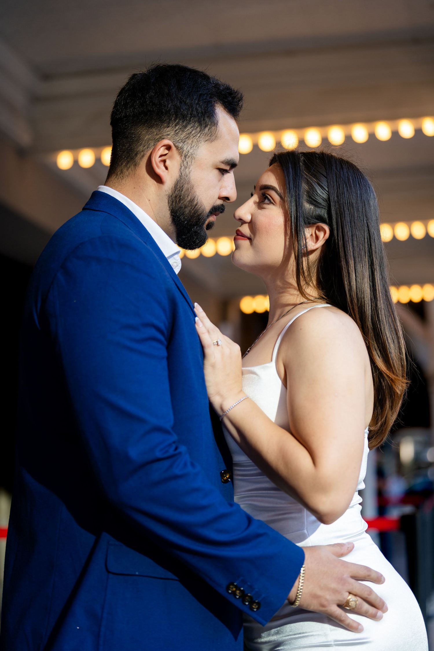 A romantic sequence of wedding photos showing a couple in white dress and blue suit sharing an intimate dance moment.