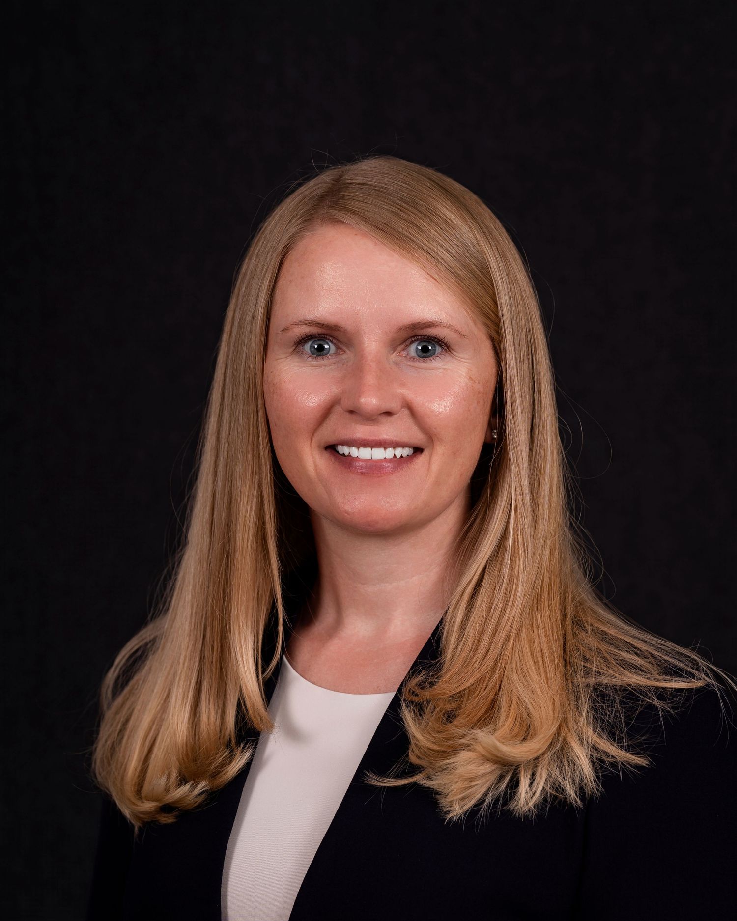 Professional headshot series against black background showing same person in different poses wearing white top.