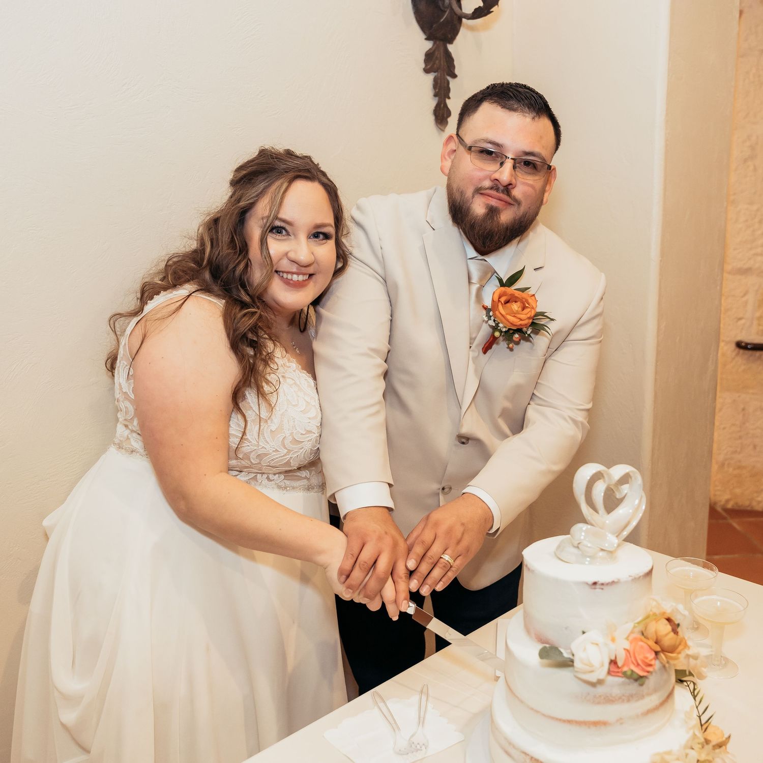 Couple cuts their wedding cake together at the reception.