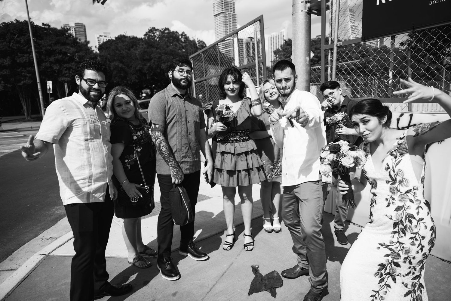 A group of friends posing together outdoors in black and white photography.