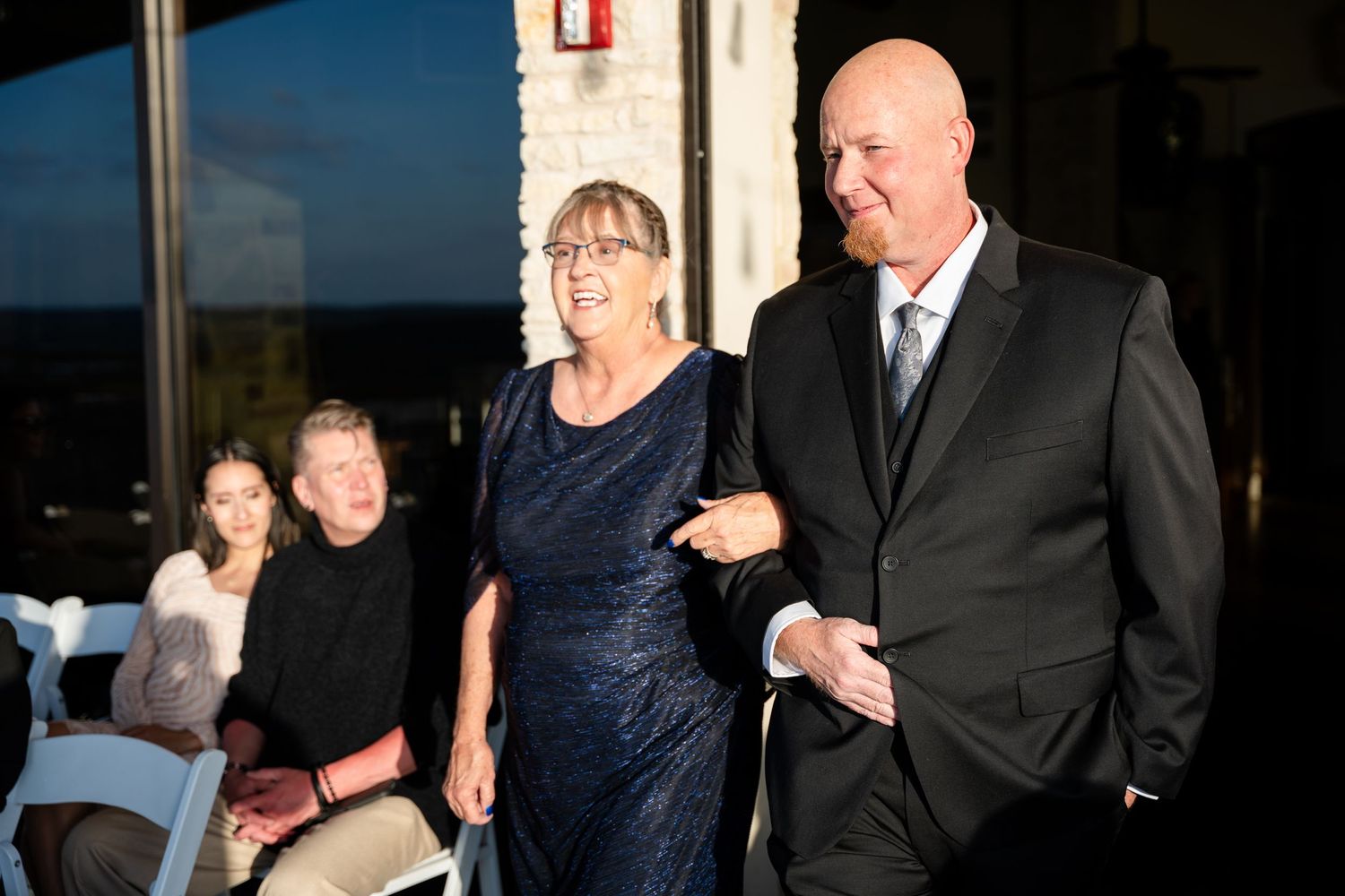 Evening wedding ceremony processional in elegant venue.
