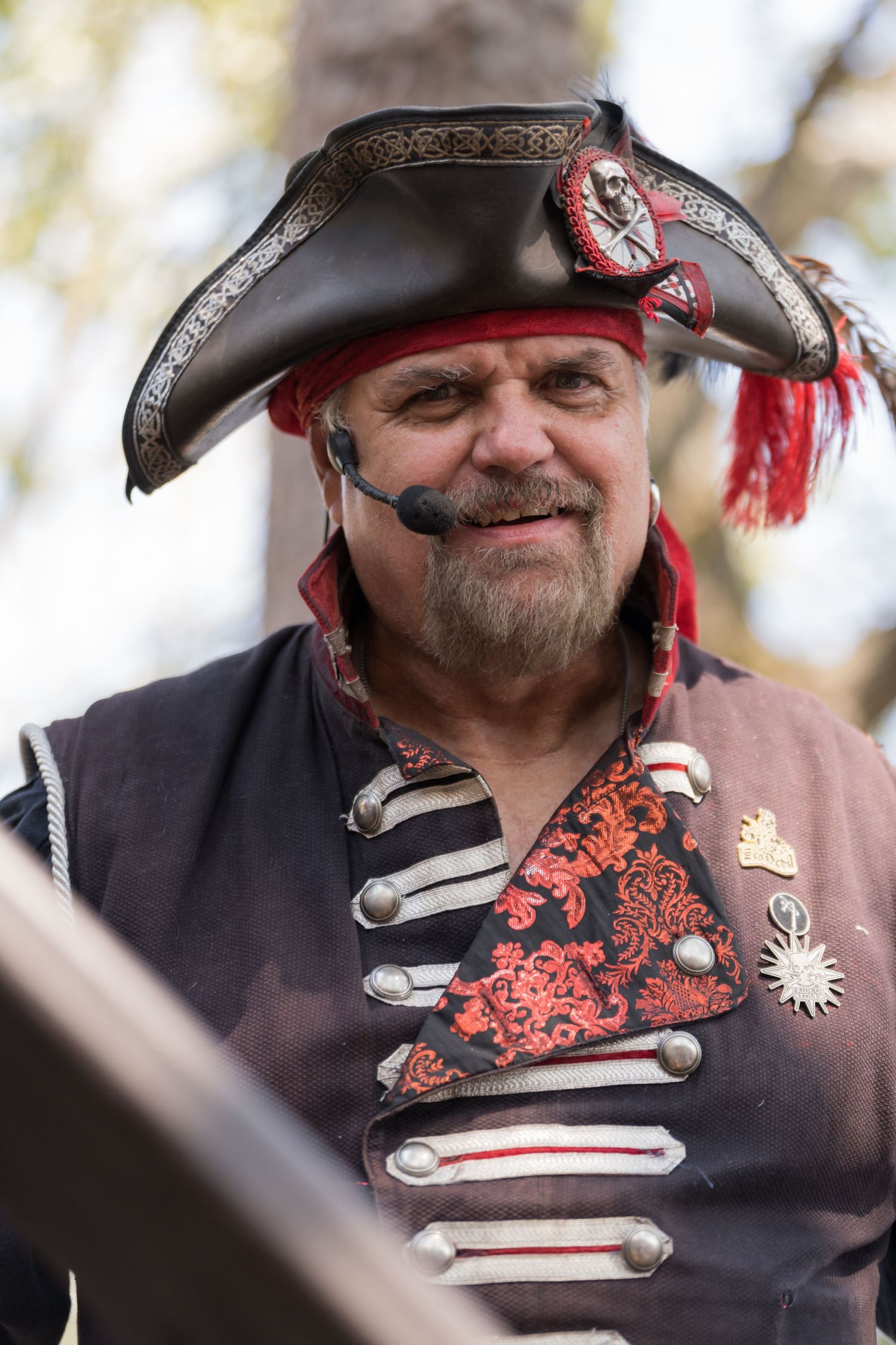 A pirate-themed performer in elaborate costume with tricorn hat and decorative uniform.