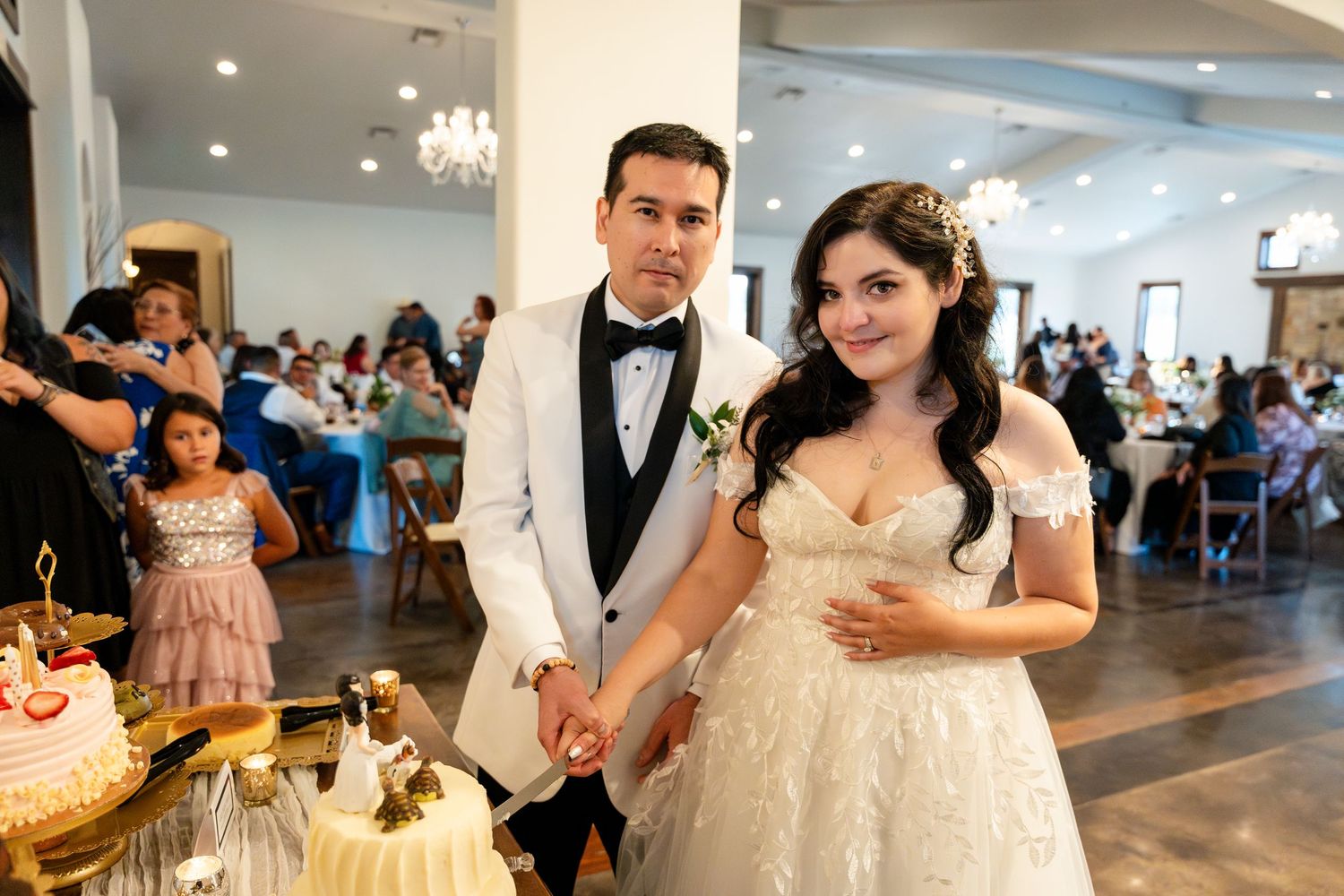 Wedding reception venue decorated with elegant centerpieces and tables set for a formal celebration.