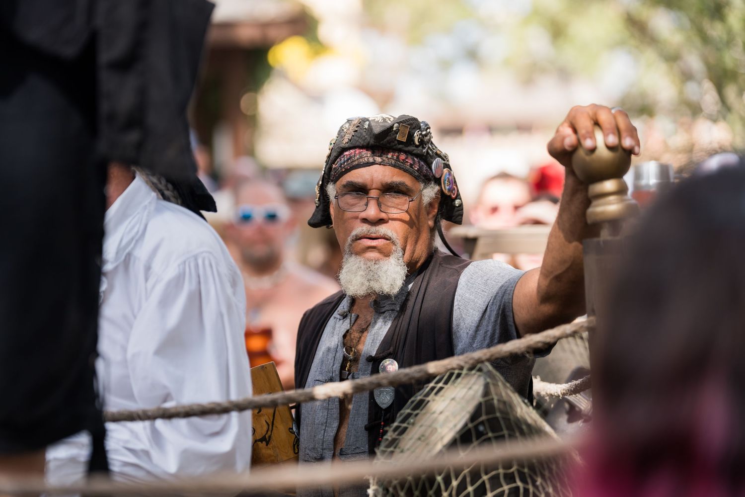 A performer in period costume gestures during a Renaissance festival presentation.