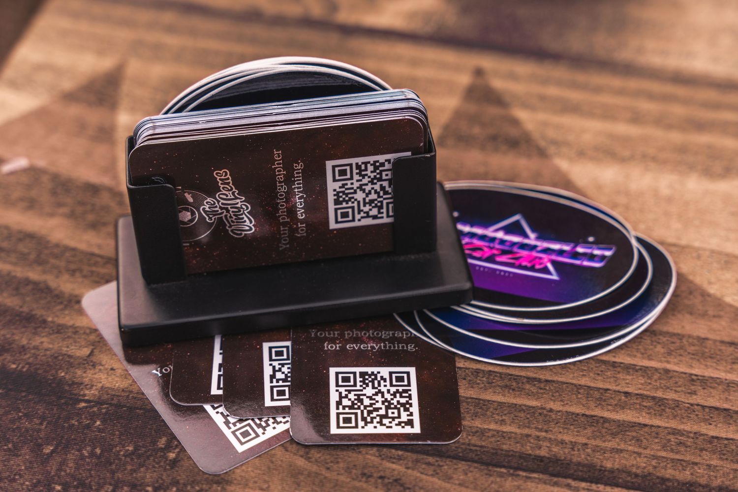 Collection of branded merchandise and QR codes displayed on wooden surface.
