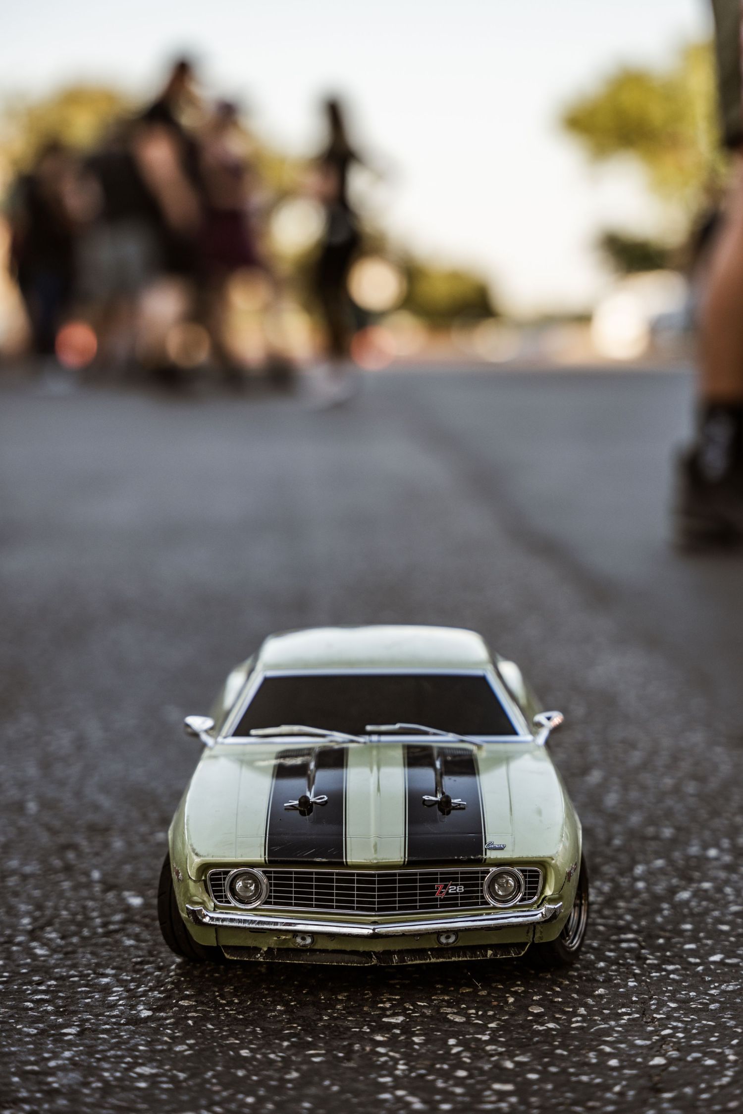 Toy model of classic Mustang muscle car photographed on asphalt.