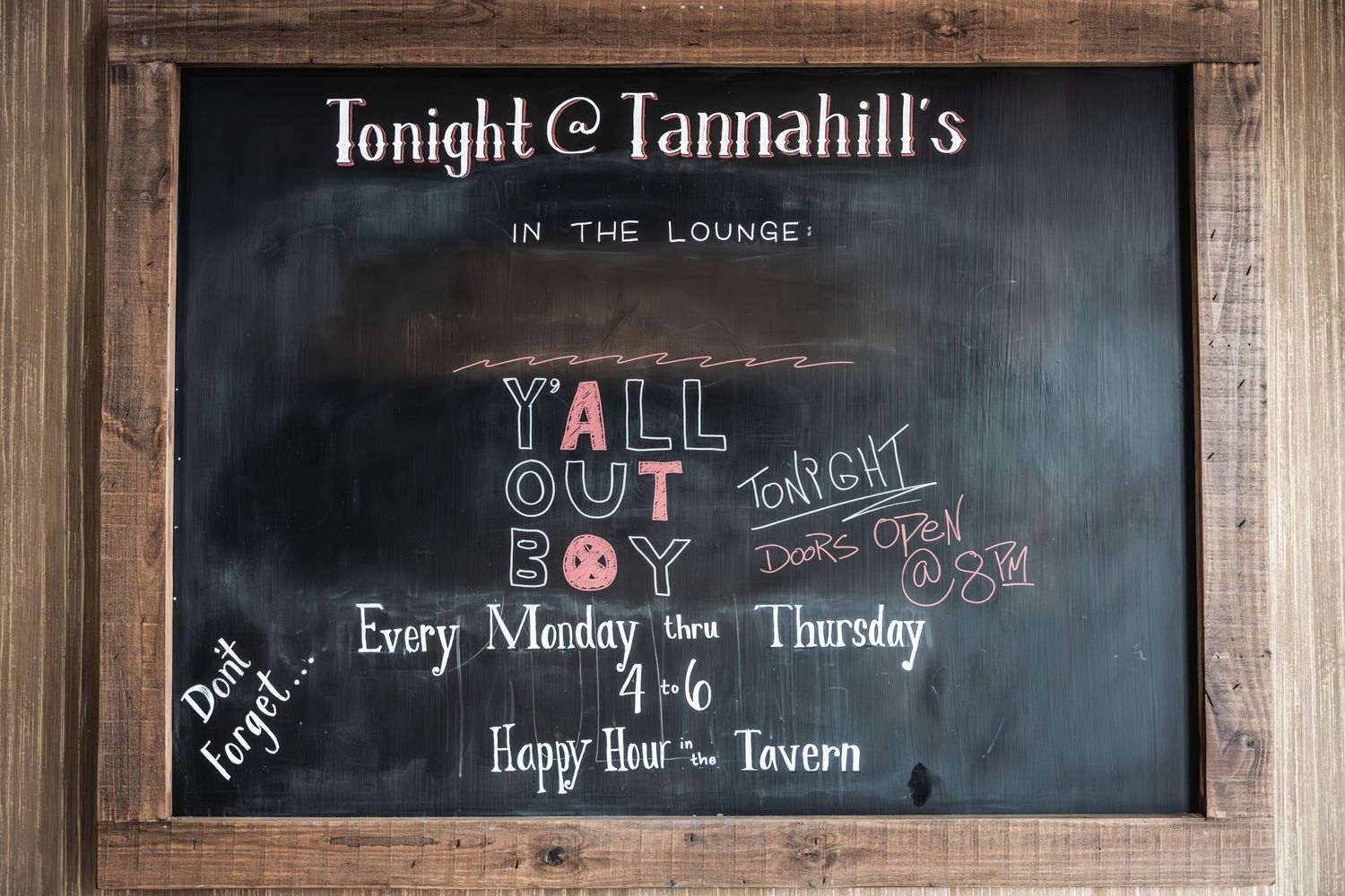 Blackboard menu at Tannahill's showing event details and happy hour specials.