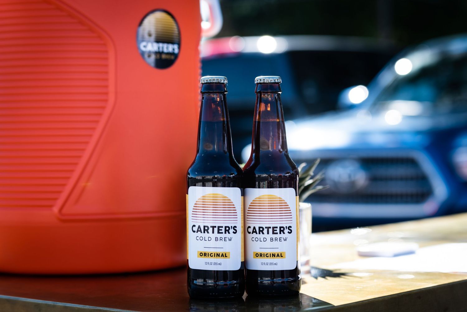 Two bottles of Carter's Cold Brew coffee displayed against a red background.
