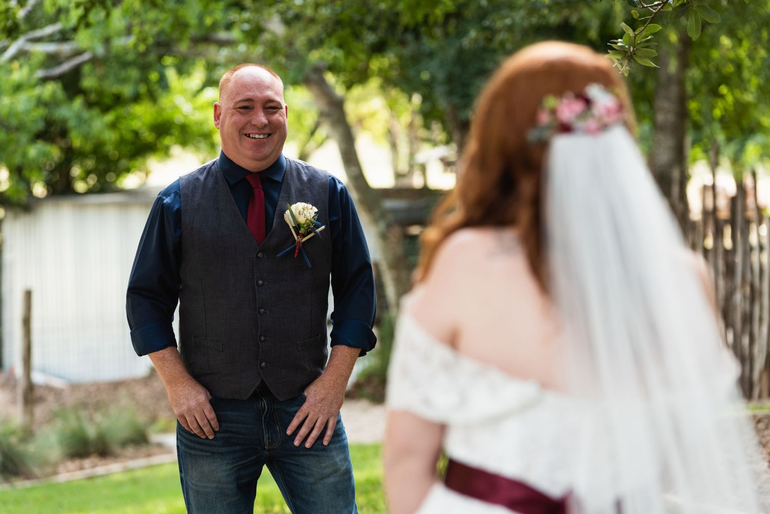 Wedding moment captured outdoors with trees in background.