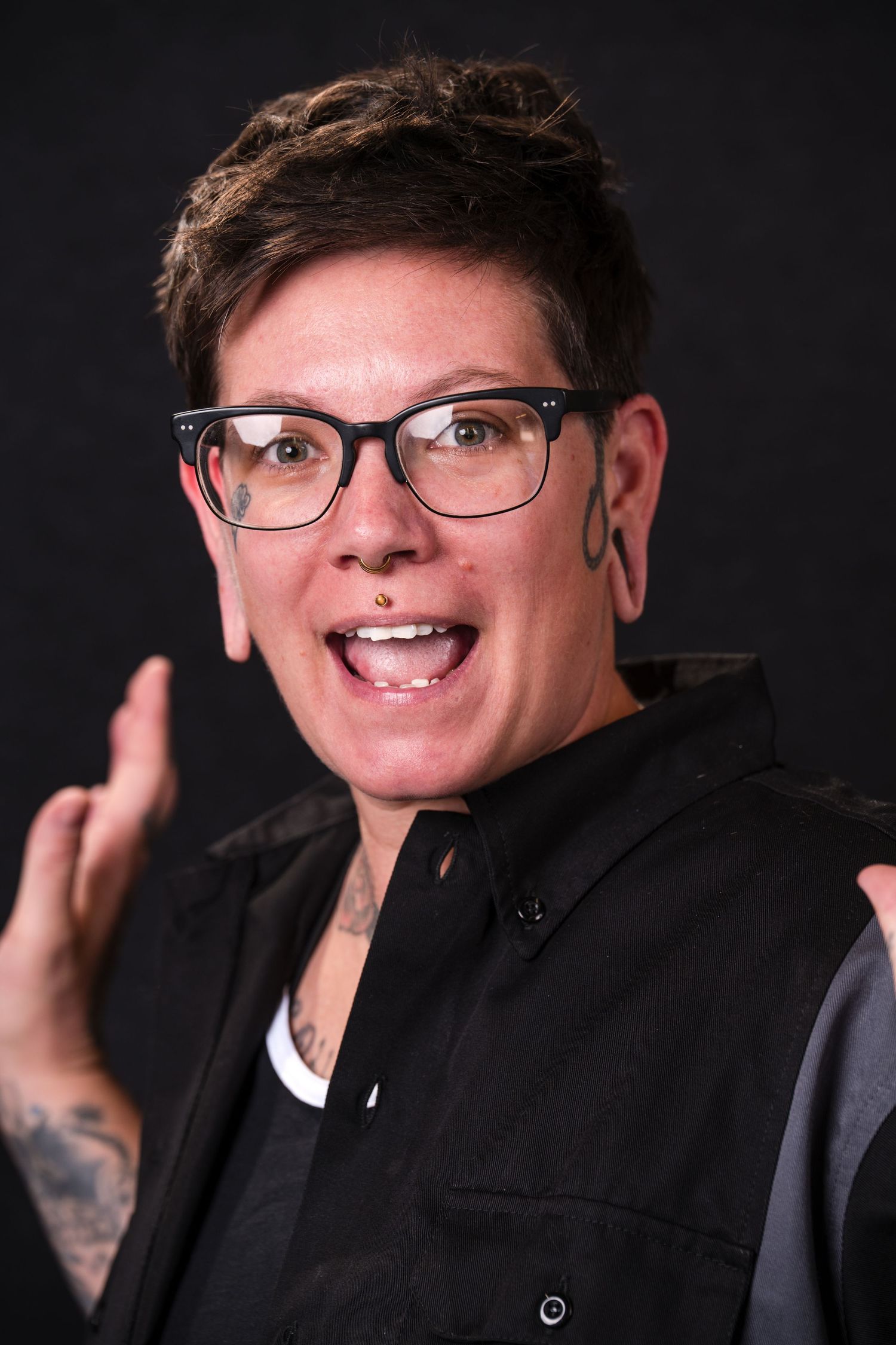 Professional headshot series showing expressions and poses against dark background wearing black clothing and glasses.