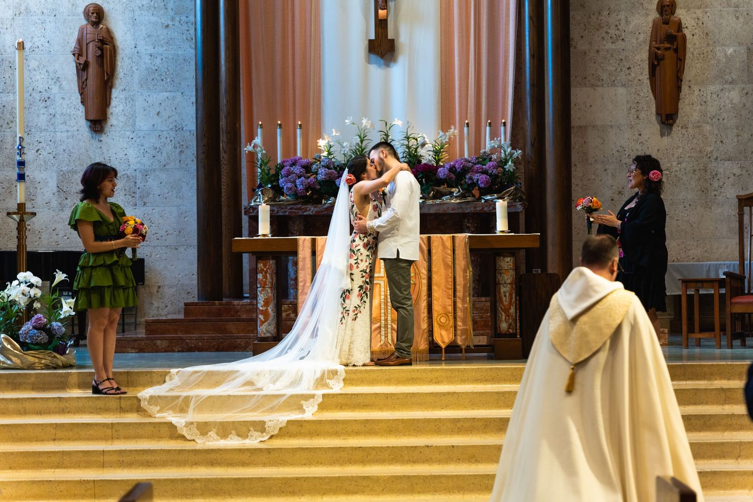 Traditional church wedding ceremony with elaborate floral altar decorations.
