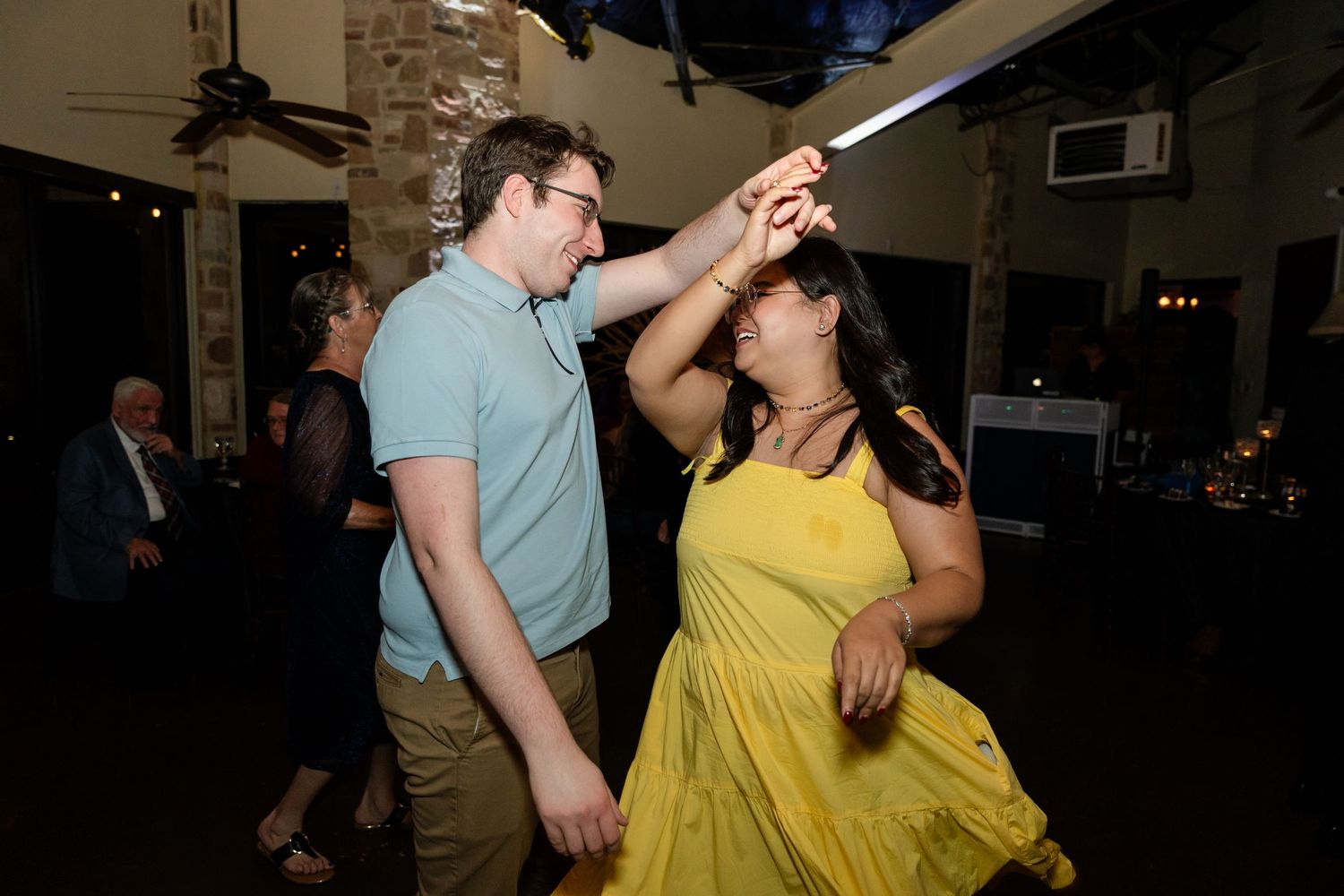 Guests dancing and having fun at wedding reception.