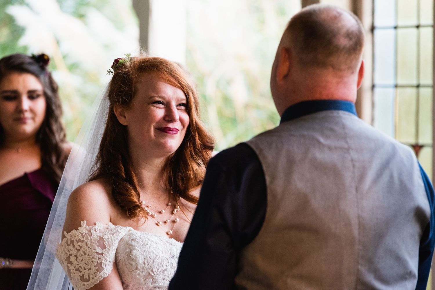 Bride shares a joyful laugh during the wedding ceremony.