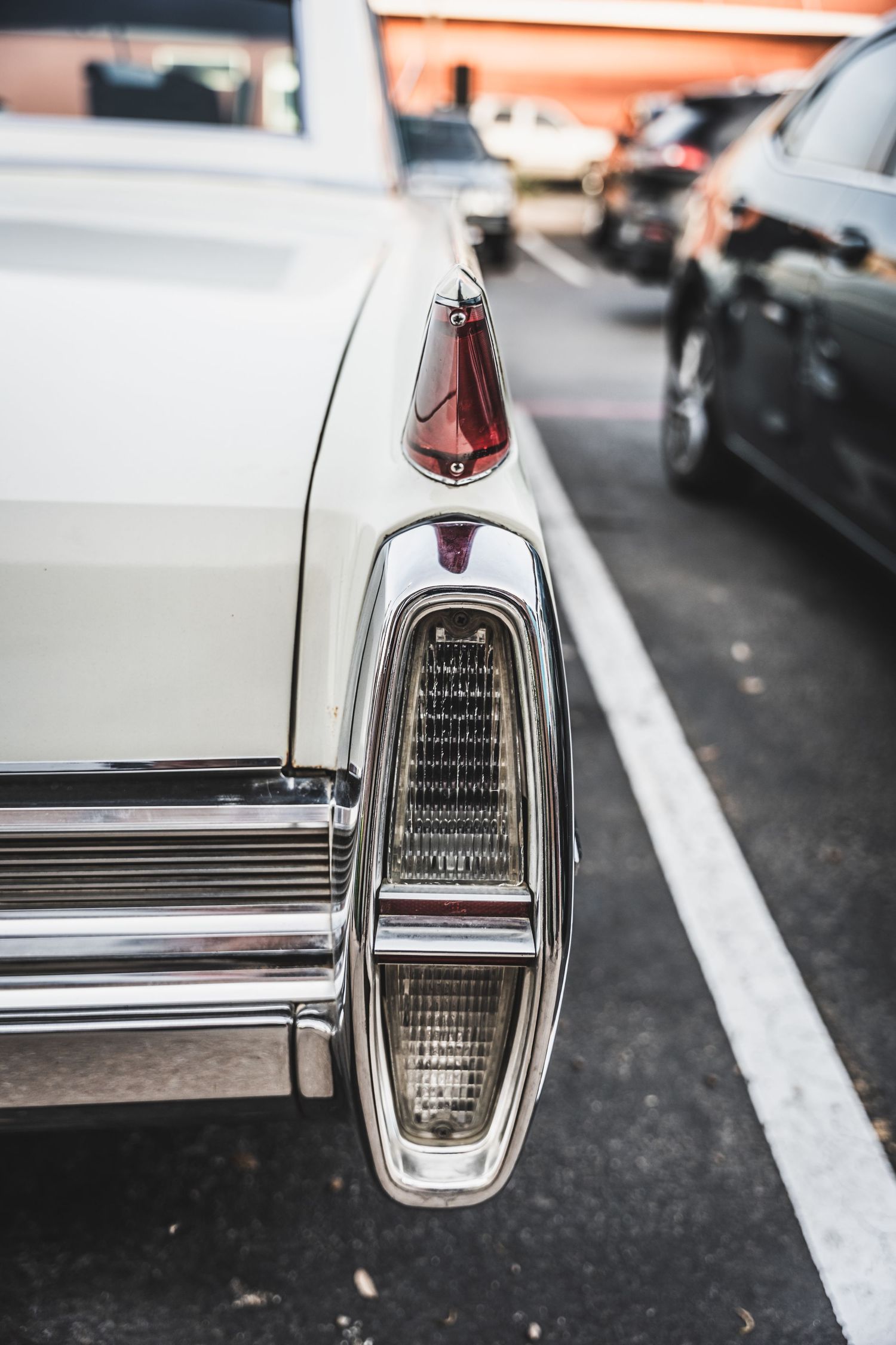 Close-up of vintage car tail light detail and chrome trim.