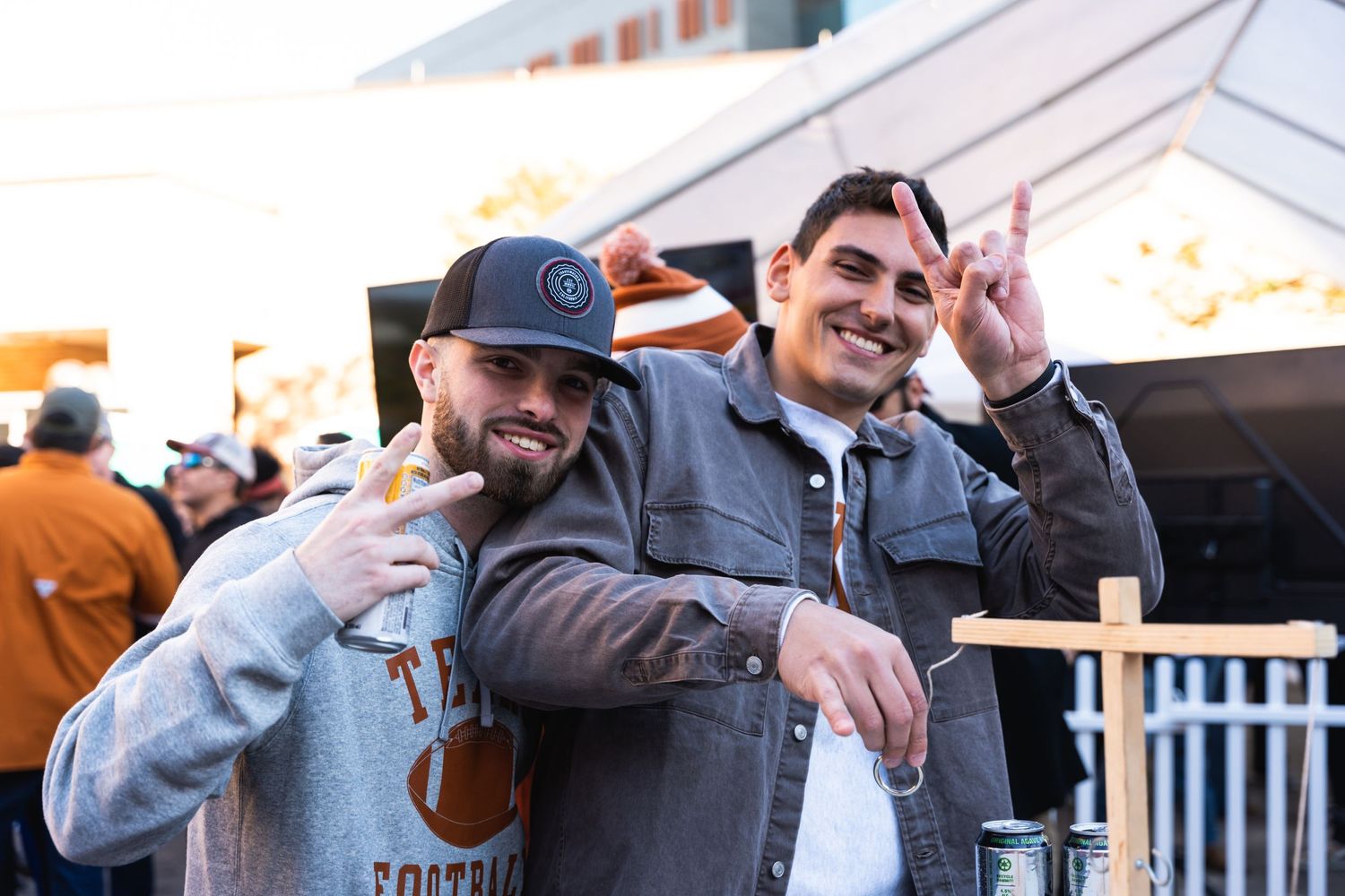 Two attendees posing together at an outdoor social gathering.