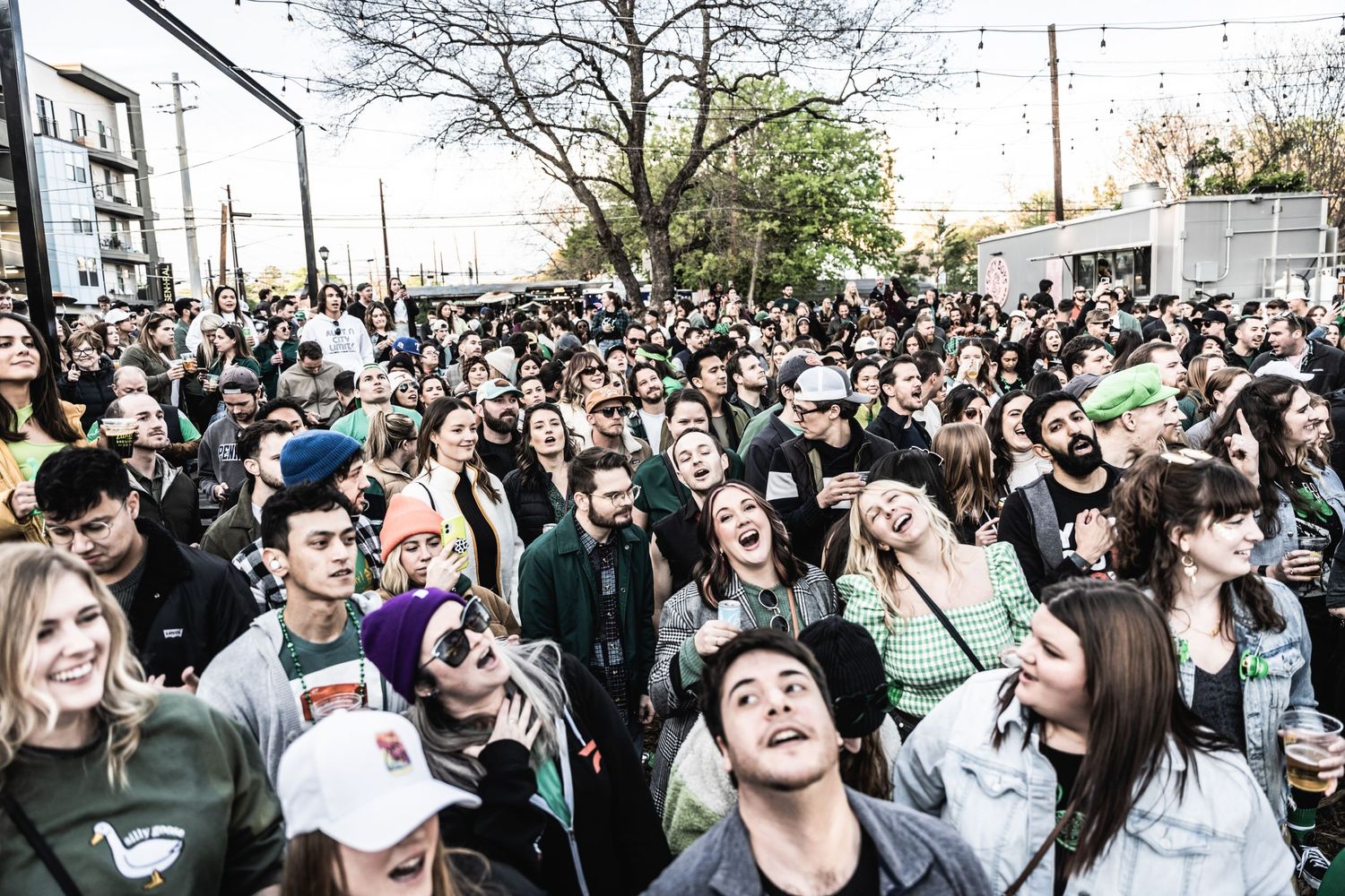 Large outdoor crowd gathering for a daytime music event or festival.