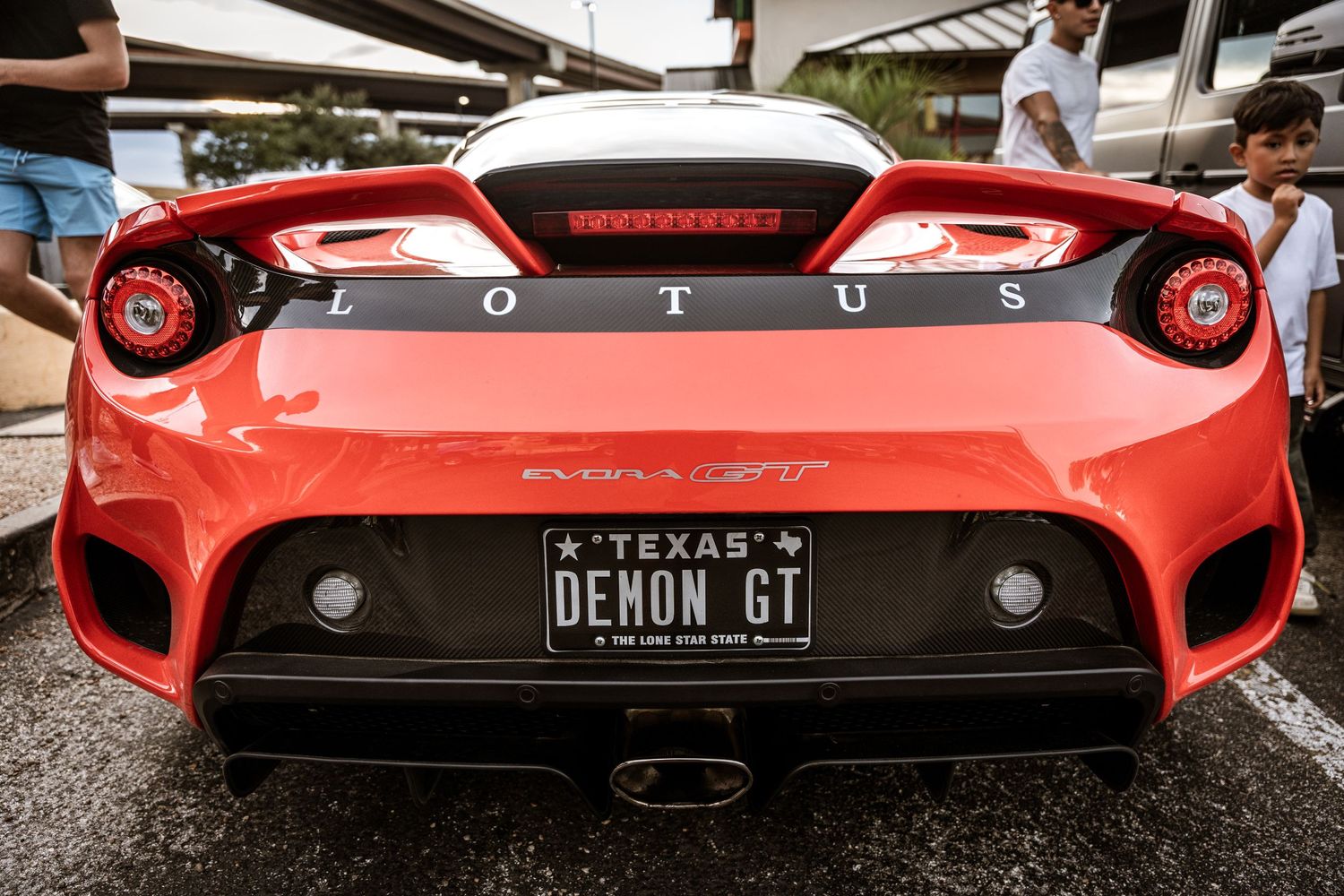 Red sports car rear end with Texas Demon GT license plate and distinctive taillights.