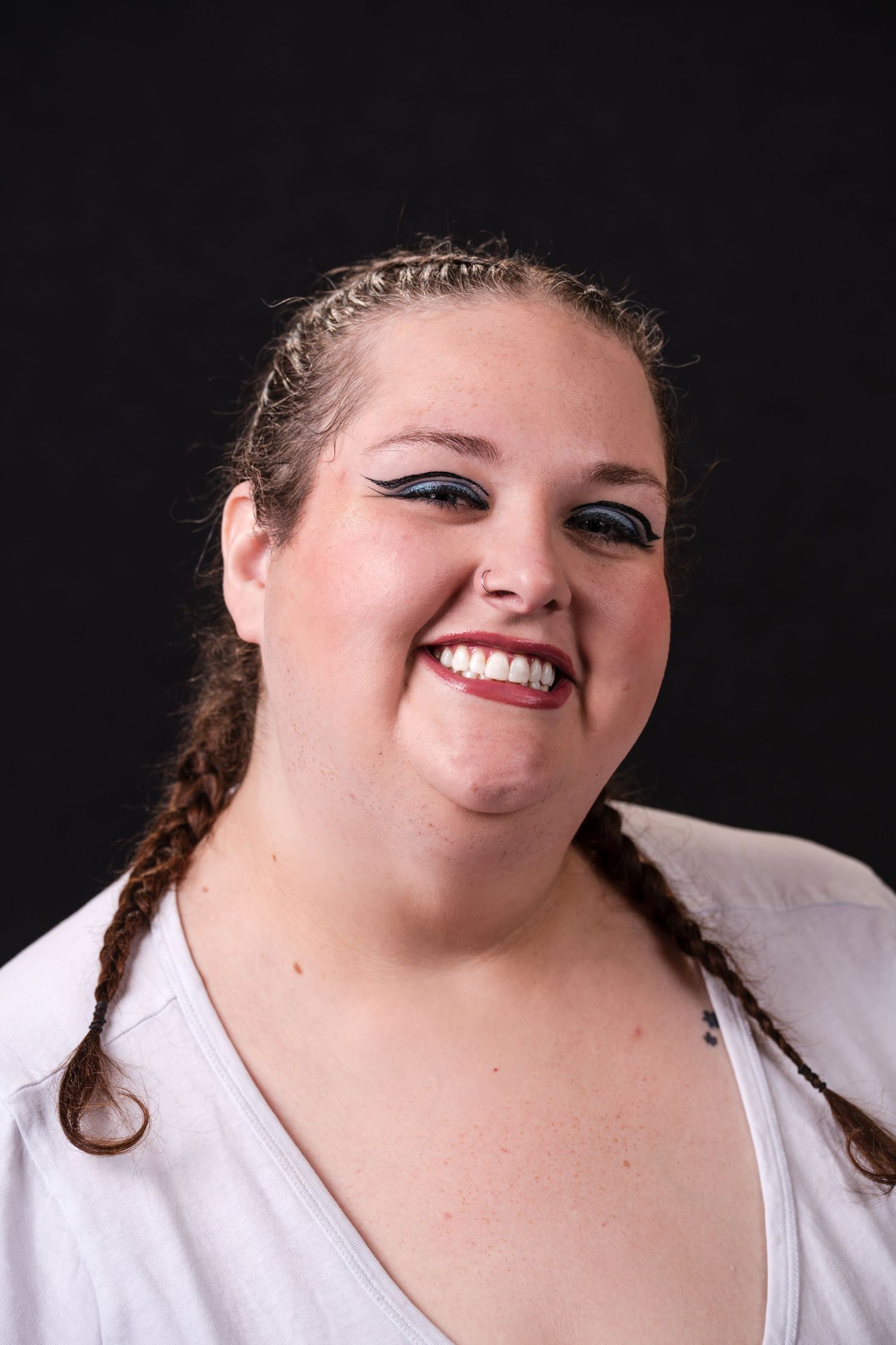 A series of expressive portrait photos showing someone wearing a white top against a black background.